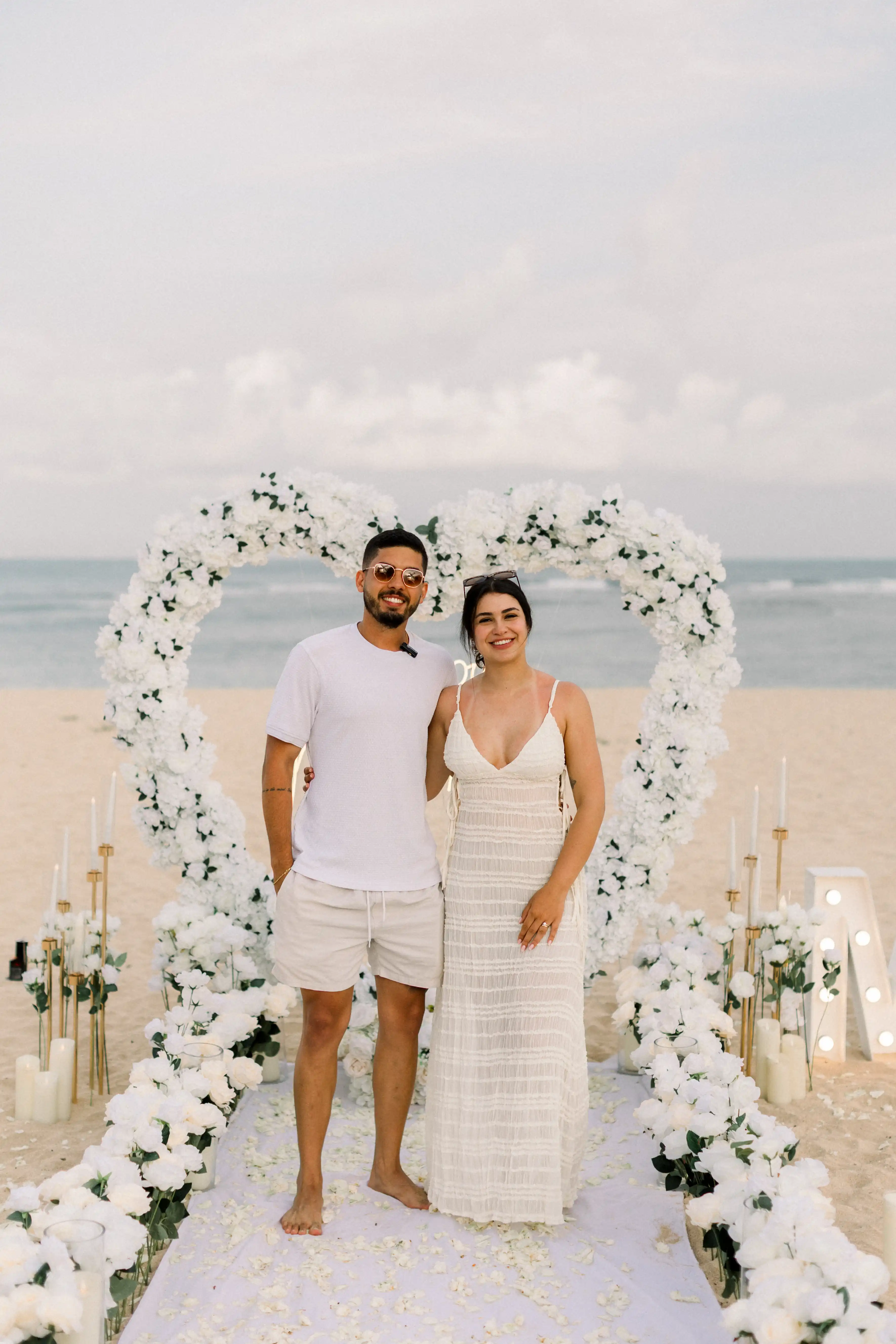 White heart-shaped flower arch with greenery accents for Bali proposal.