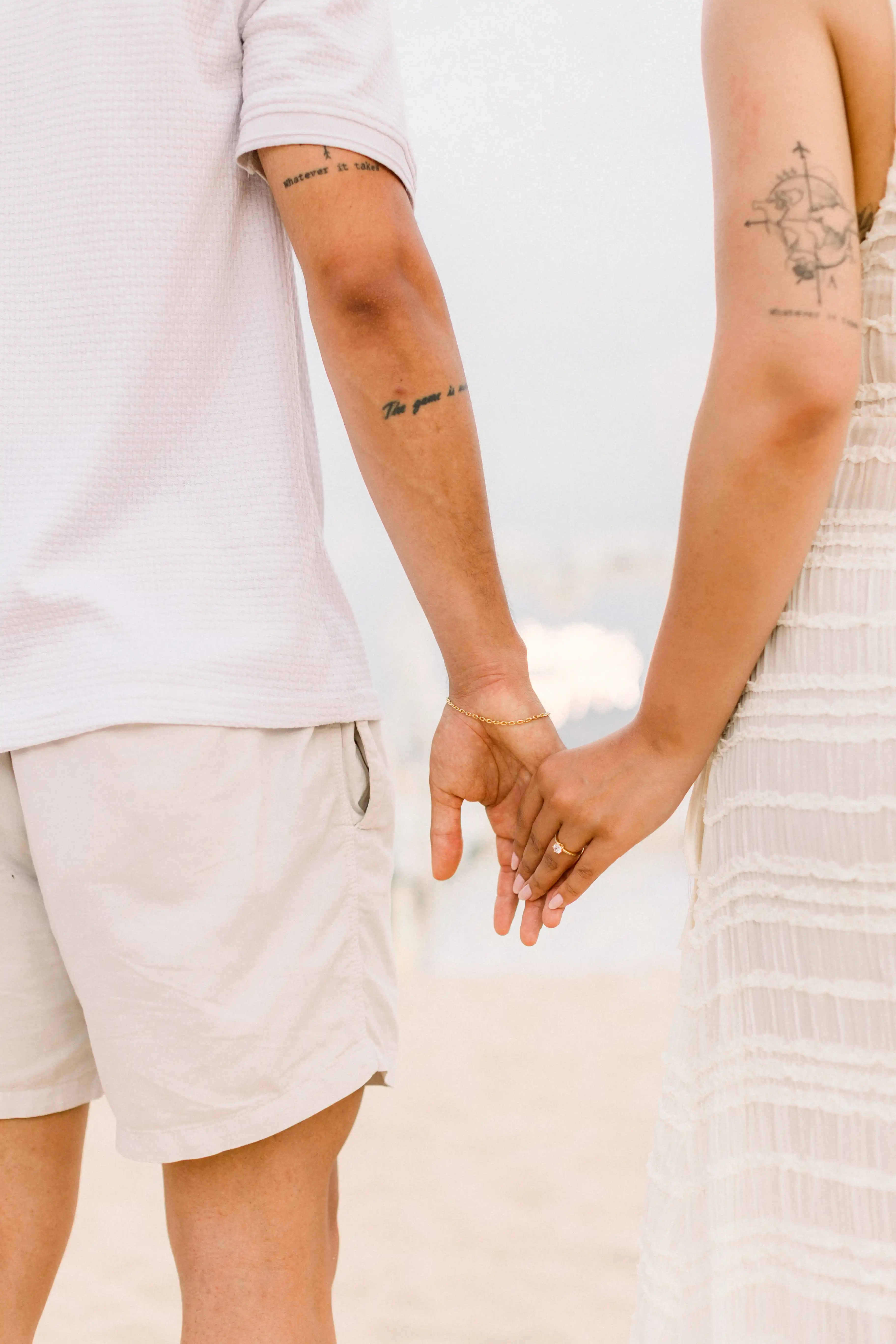 Couple walking hand in hand during their Bali proposal on the beach.