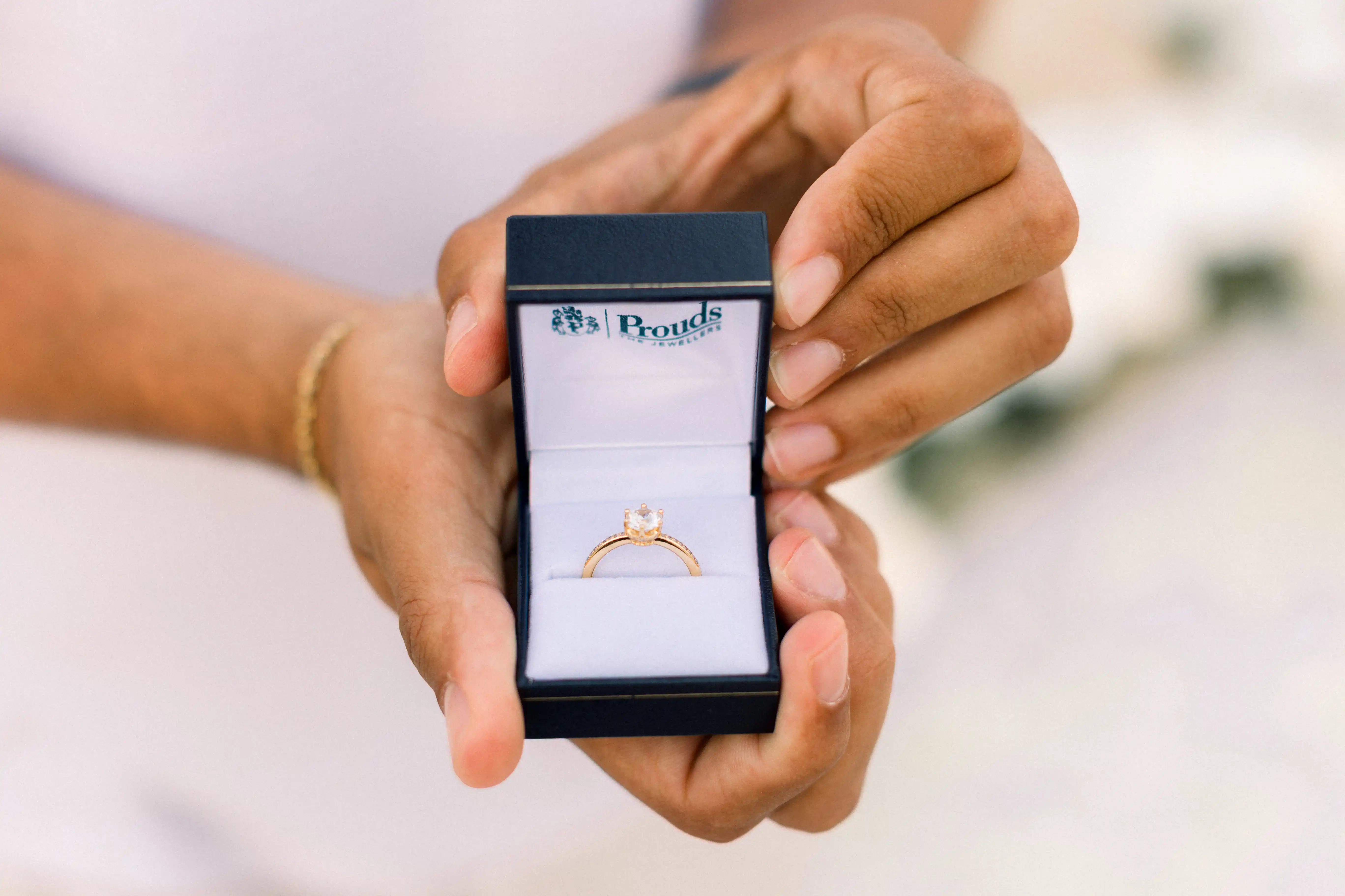 Engagement ring presented during romantic Bali beach proposal.