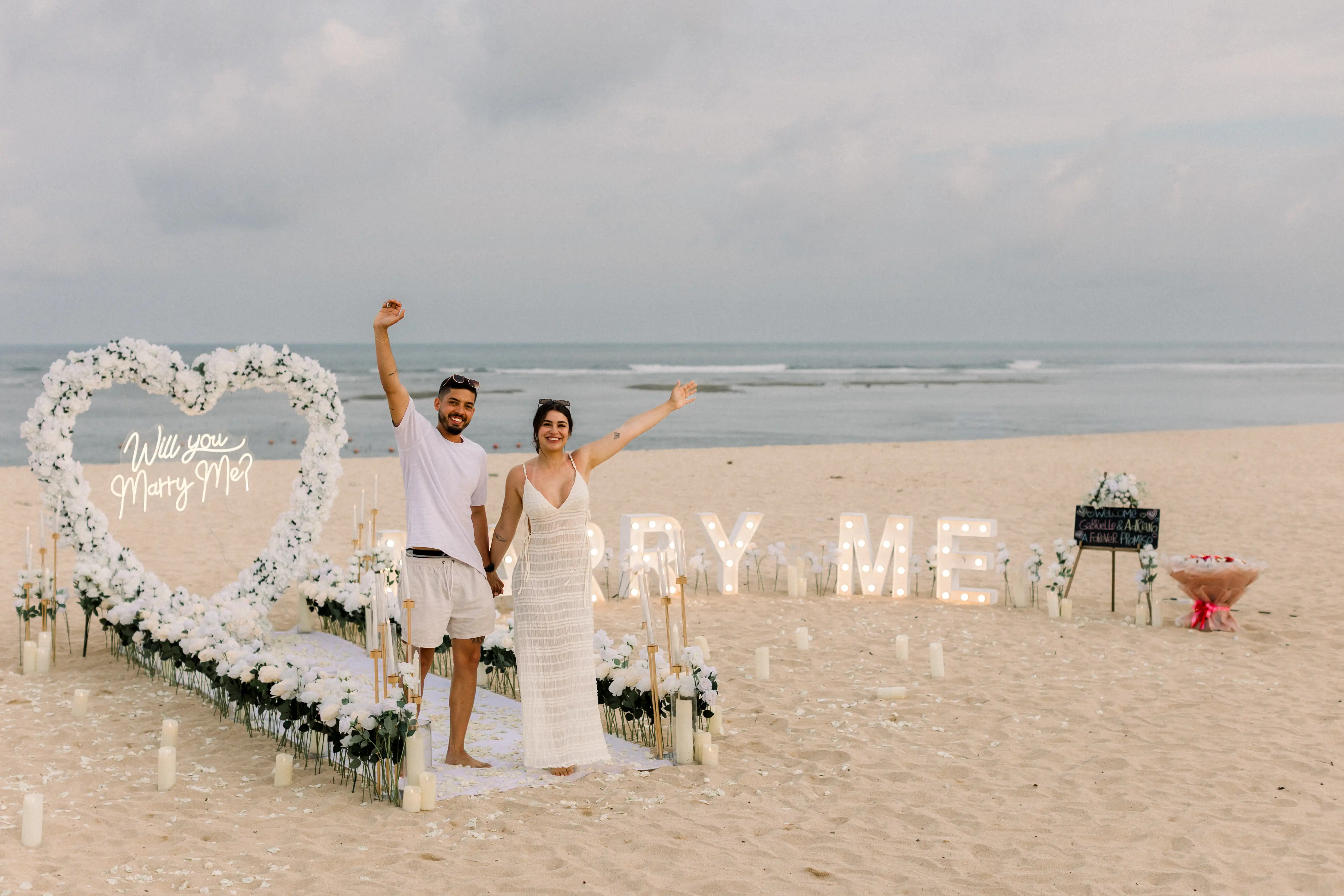 Private beach dinner setup after a romantic proposal in Bali.