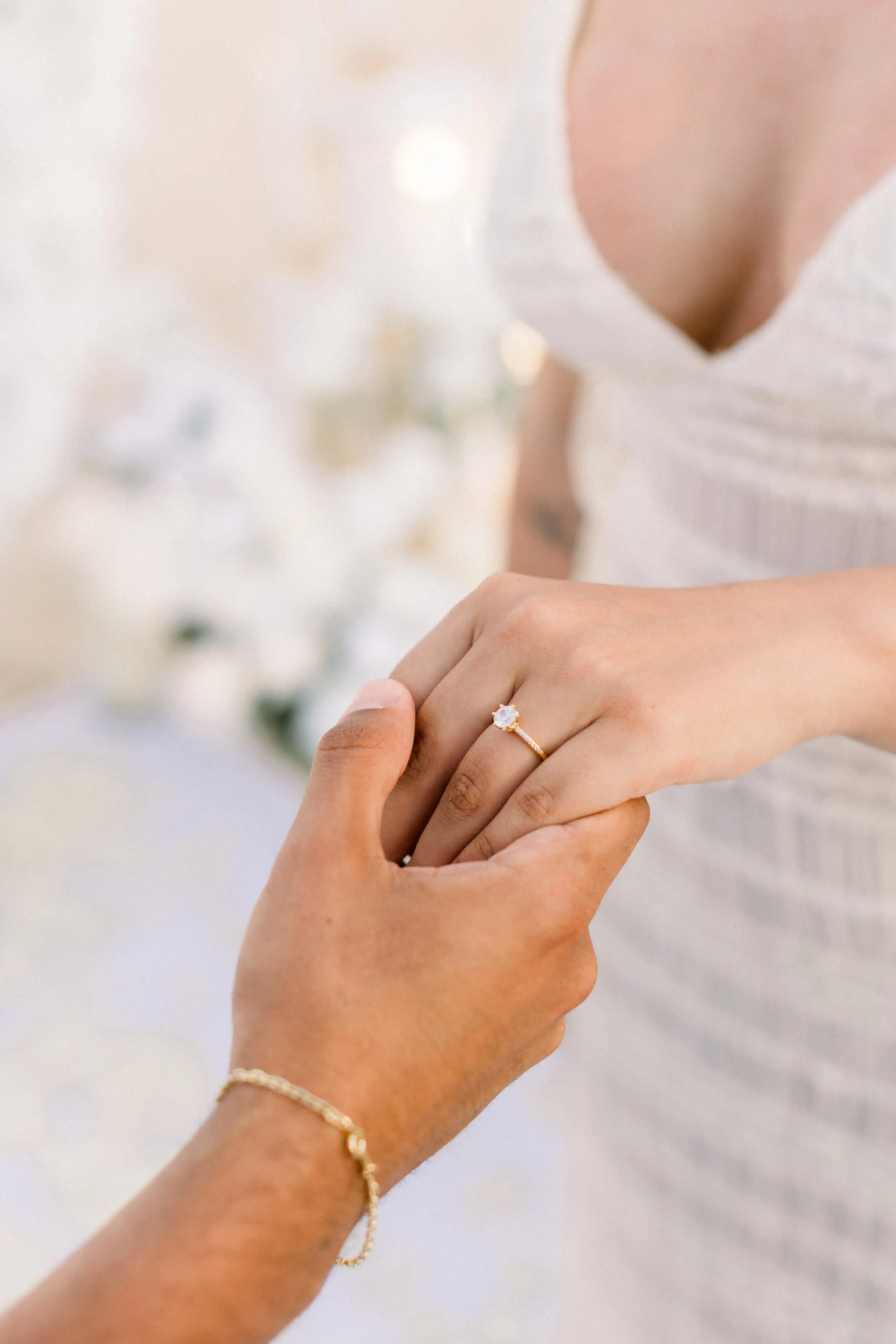Close-up of engagement ring exchange during Bali beach proposal.