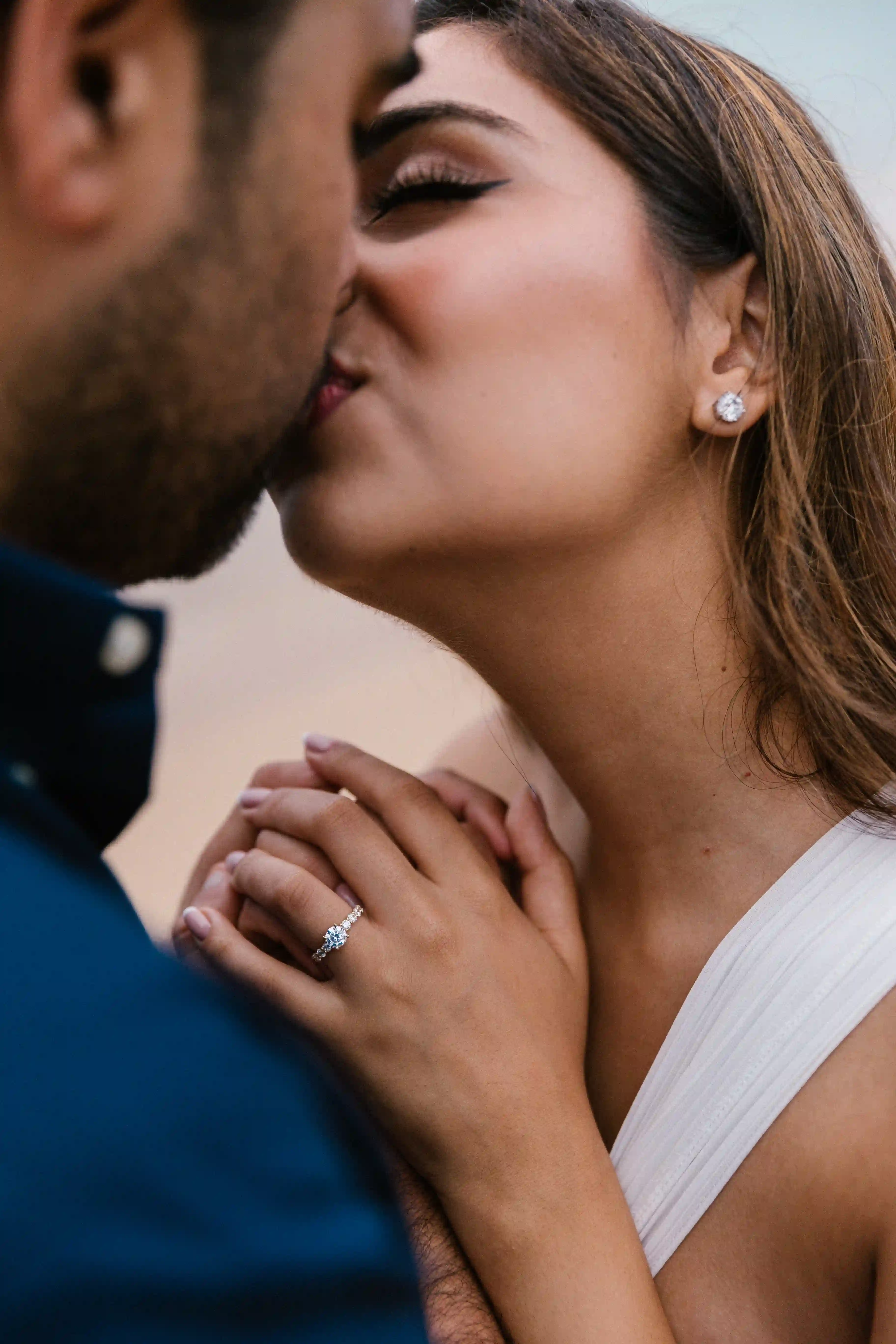 Intimate kiss after a luxury beach marriage proposal in Bali
