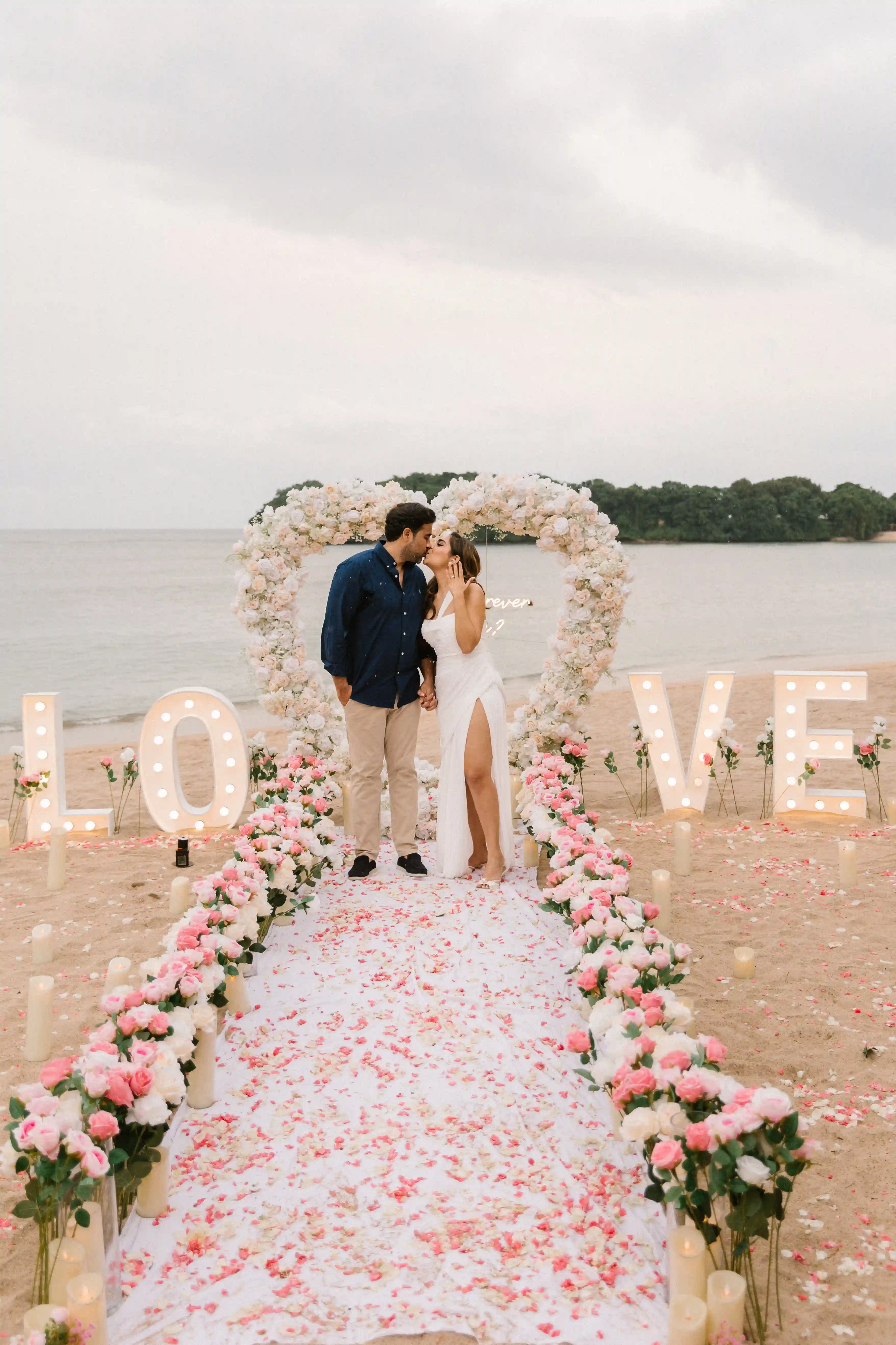 Floral heart arch centerpiece of an exclusive beach proposal in Bali