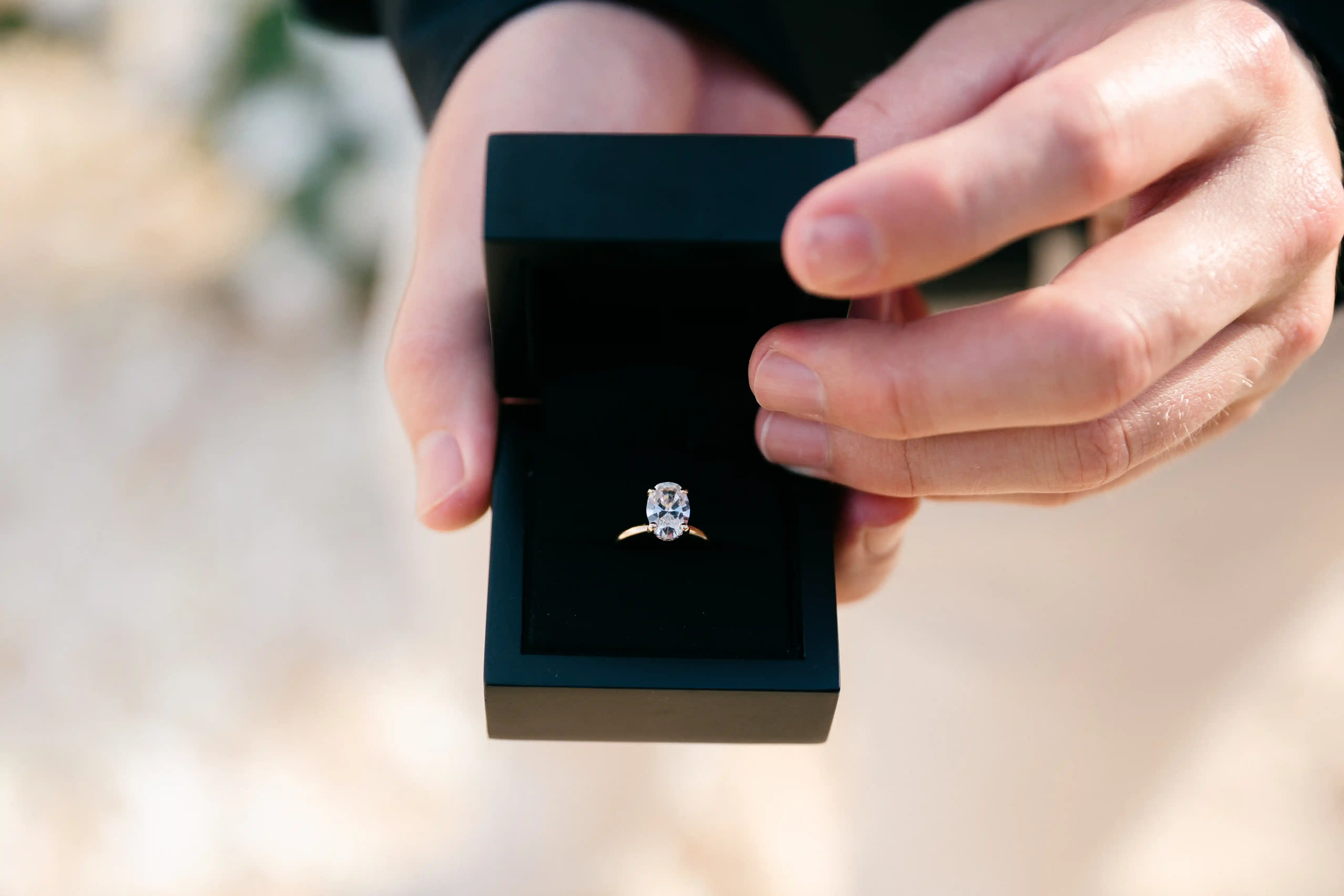 Close-up of the engagement ring inside a black ring box.