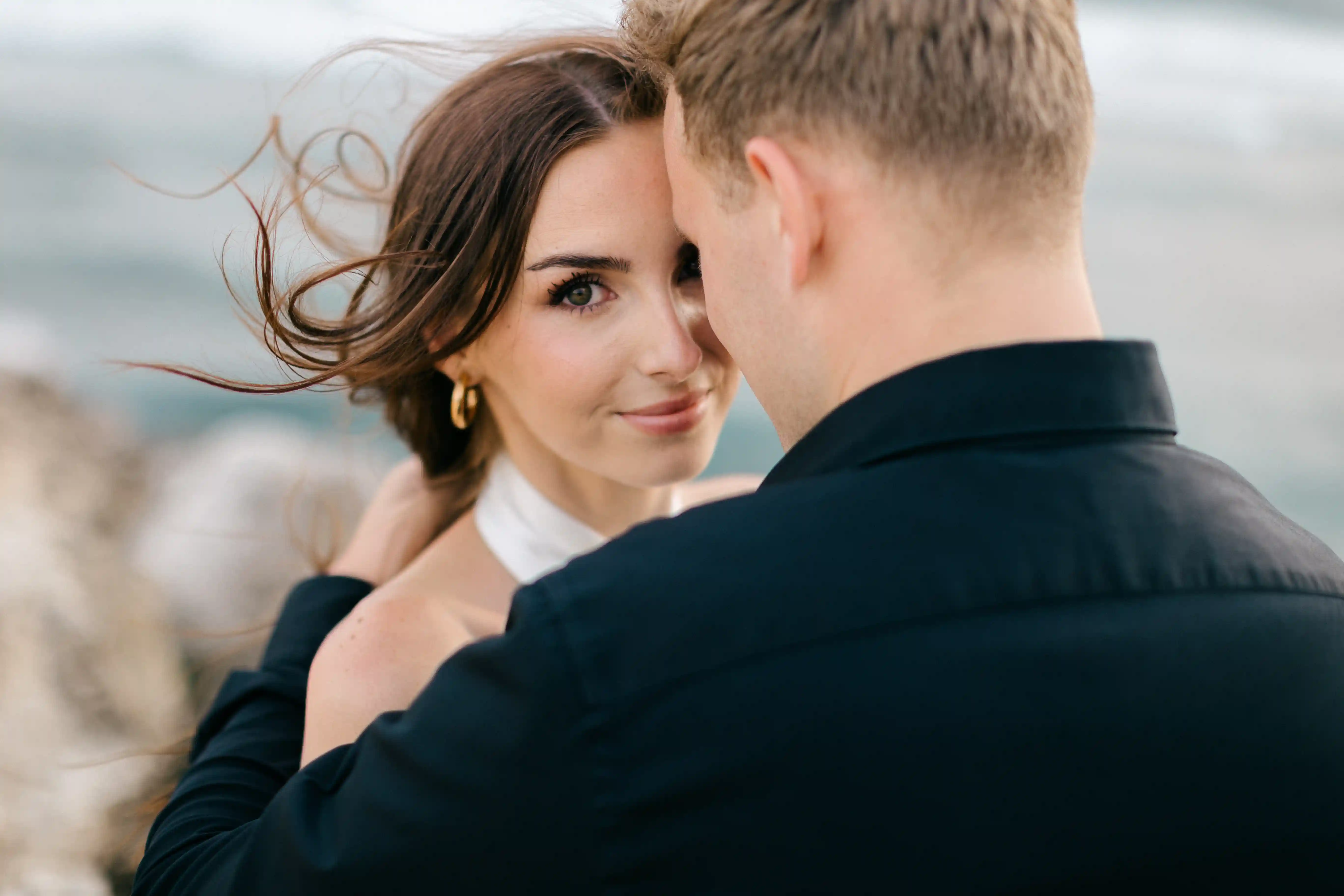 Close-up couple portrait with soft ocean breeze and natural light.