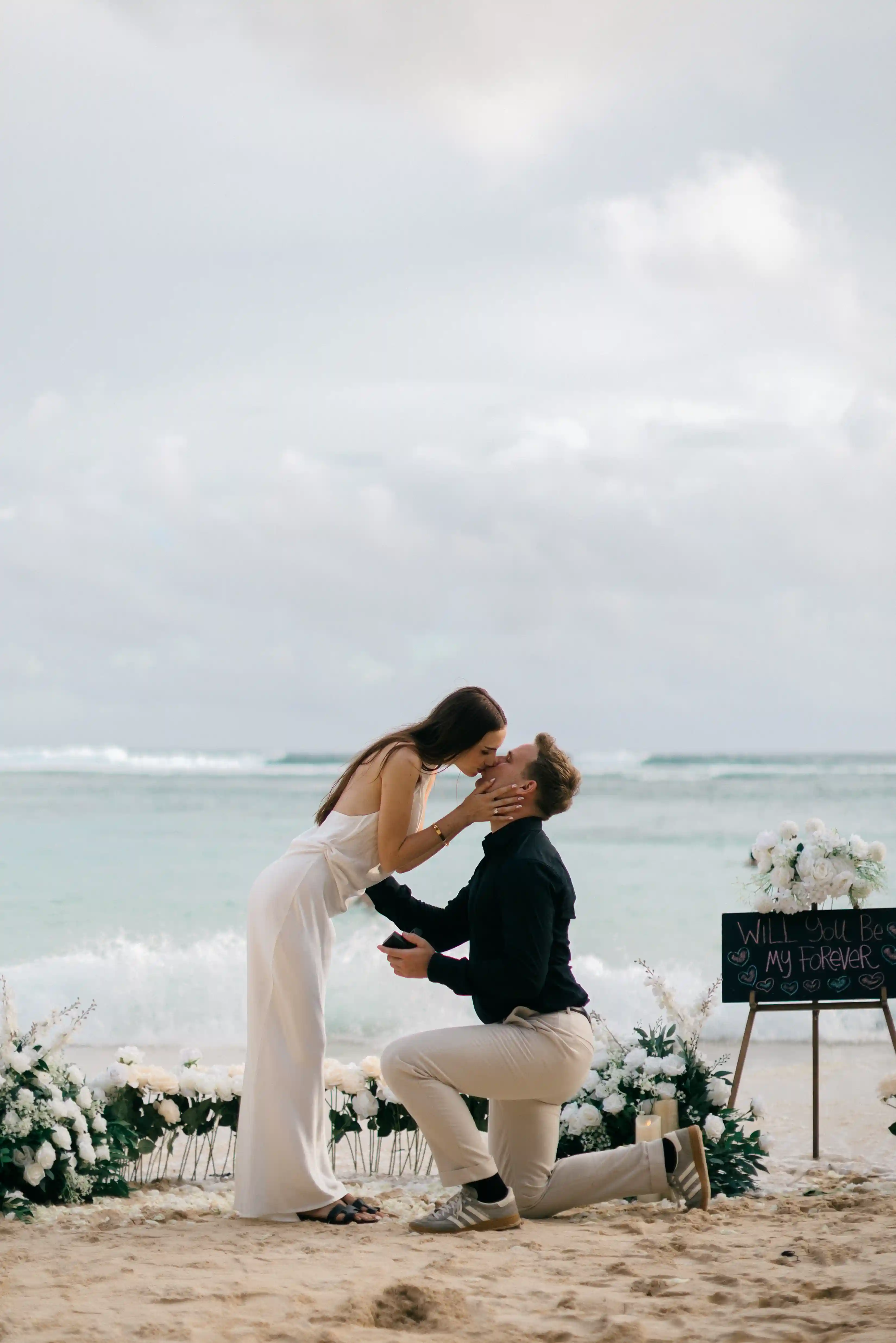 Lucas placing the engagement ring on Jasmin’s finger during the proposal.