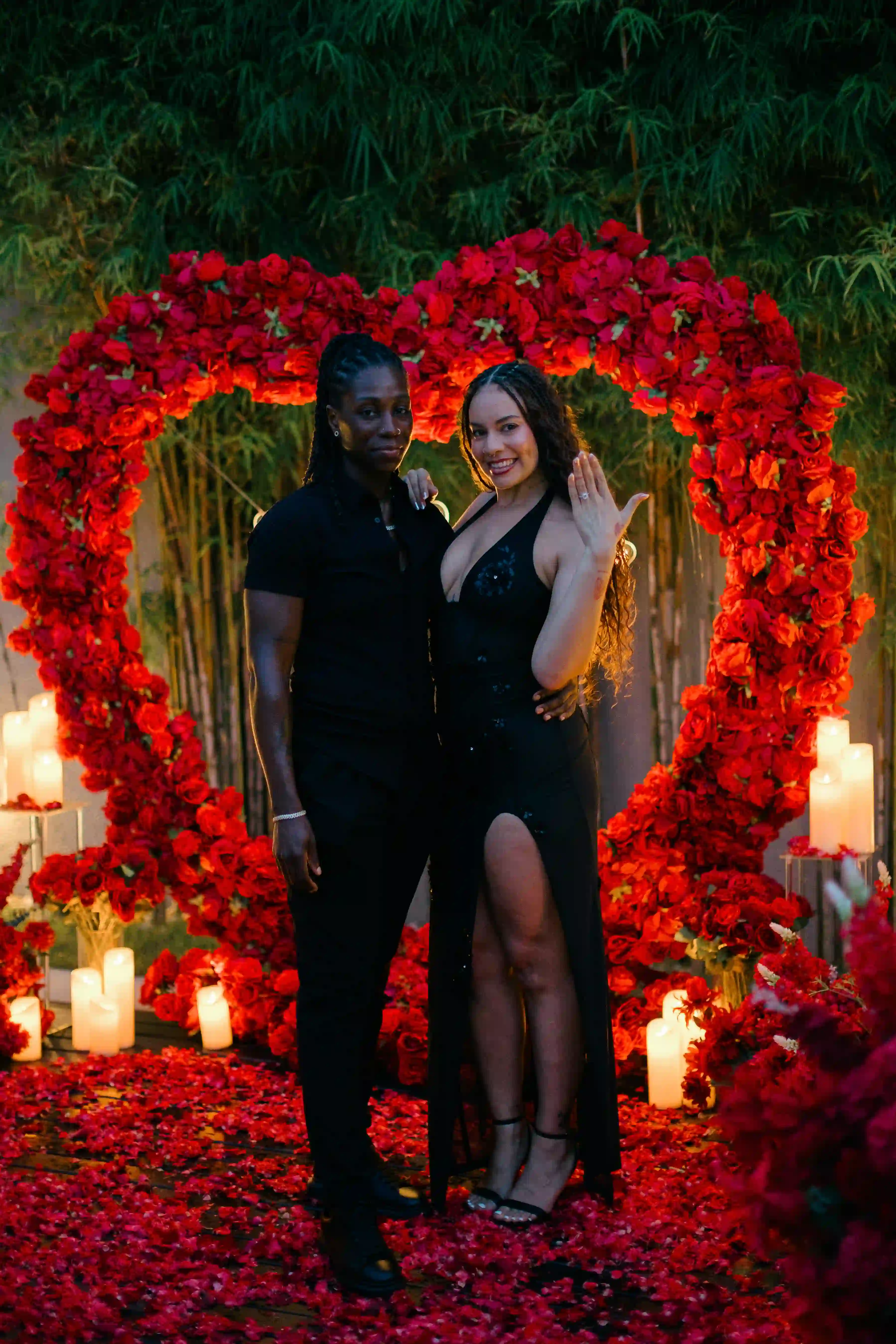 Couple standing inside heart-shaped red rose proposal setup at Bali villa
