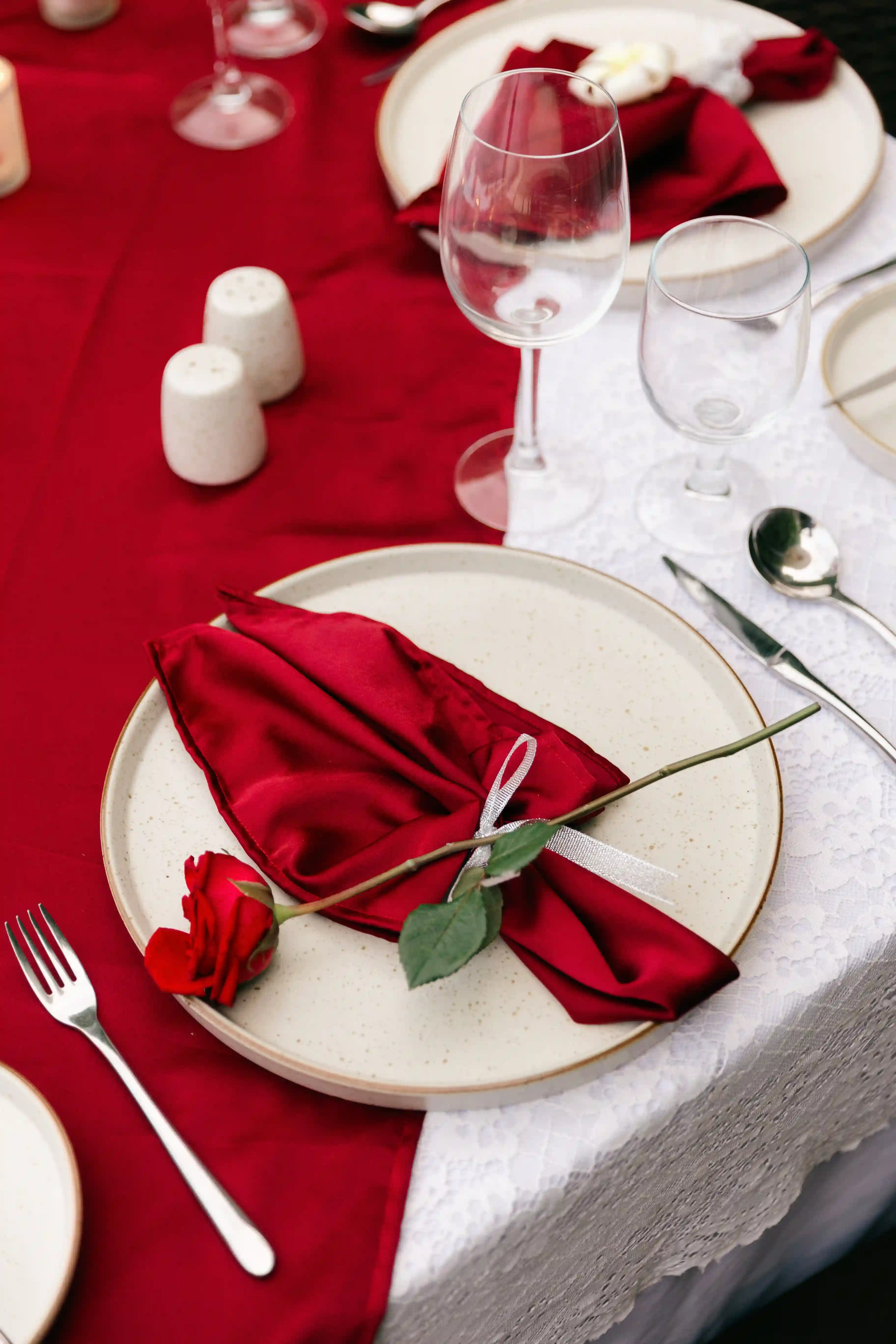 Elegant romantic dinner table setup with red rose decor at Bali villa proposal