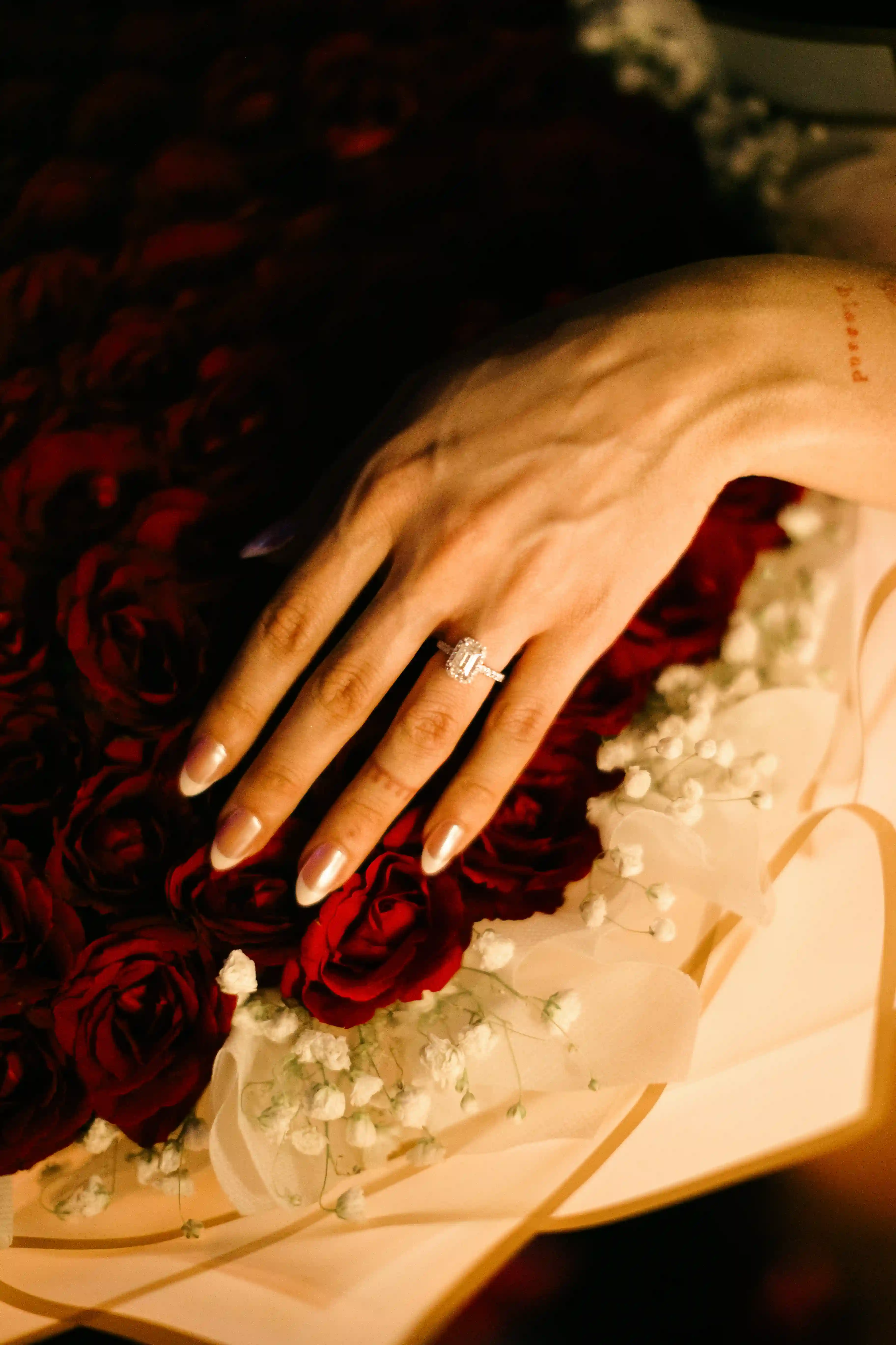 Close-up of engagement ring placed on red rose petals after Bali proposal