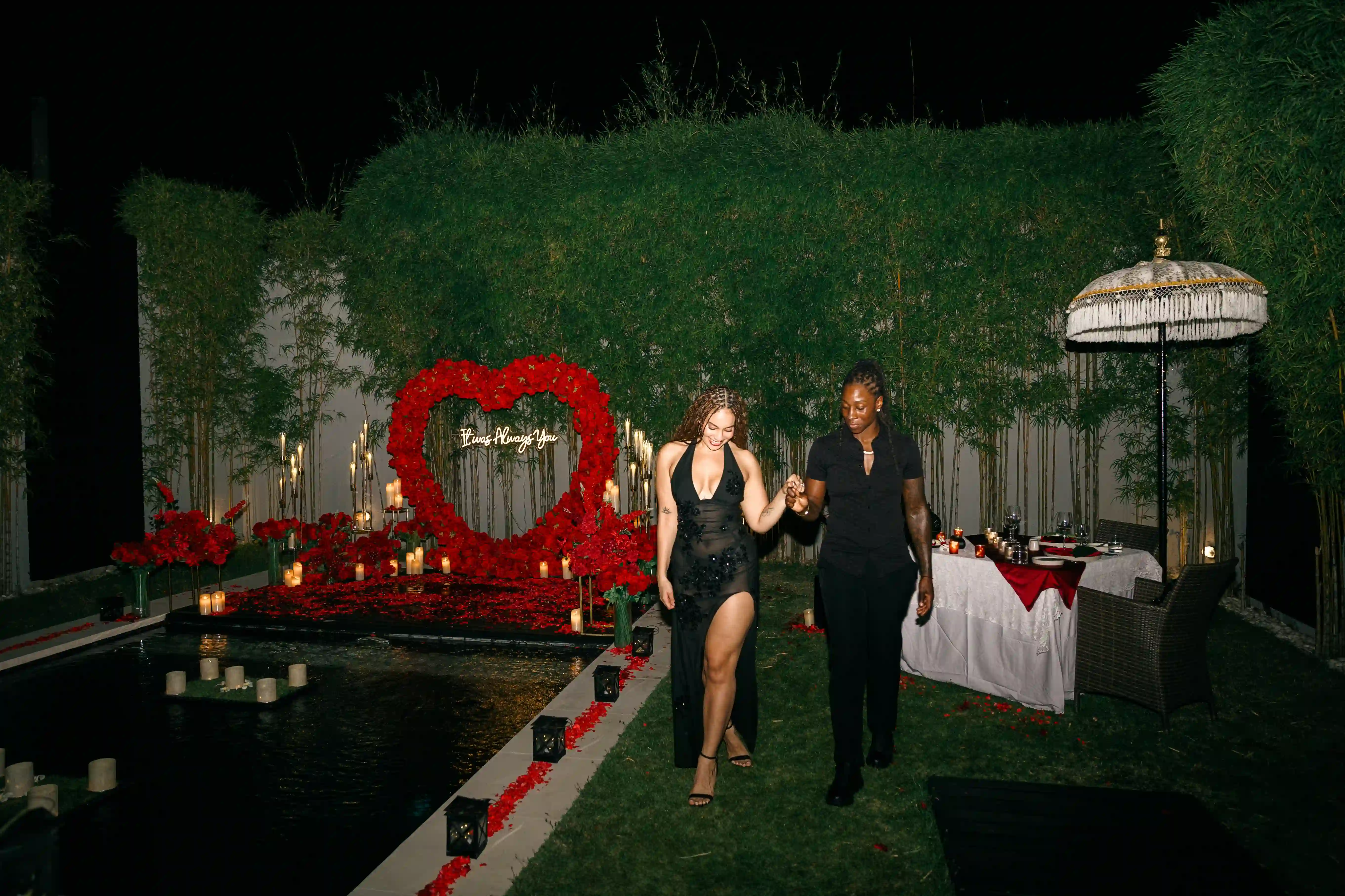 Couple embracing inside heart-shaped red rose proposal decoration in Bali