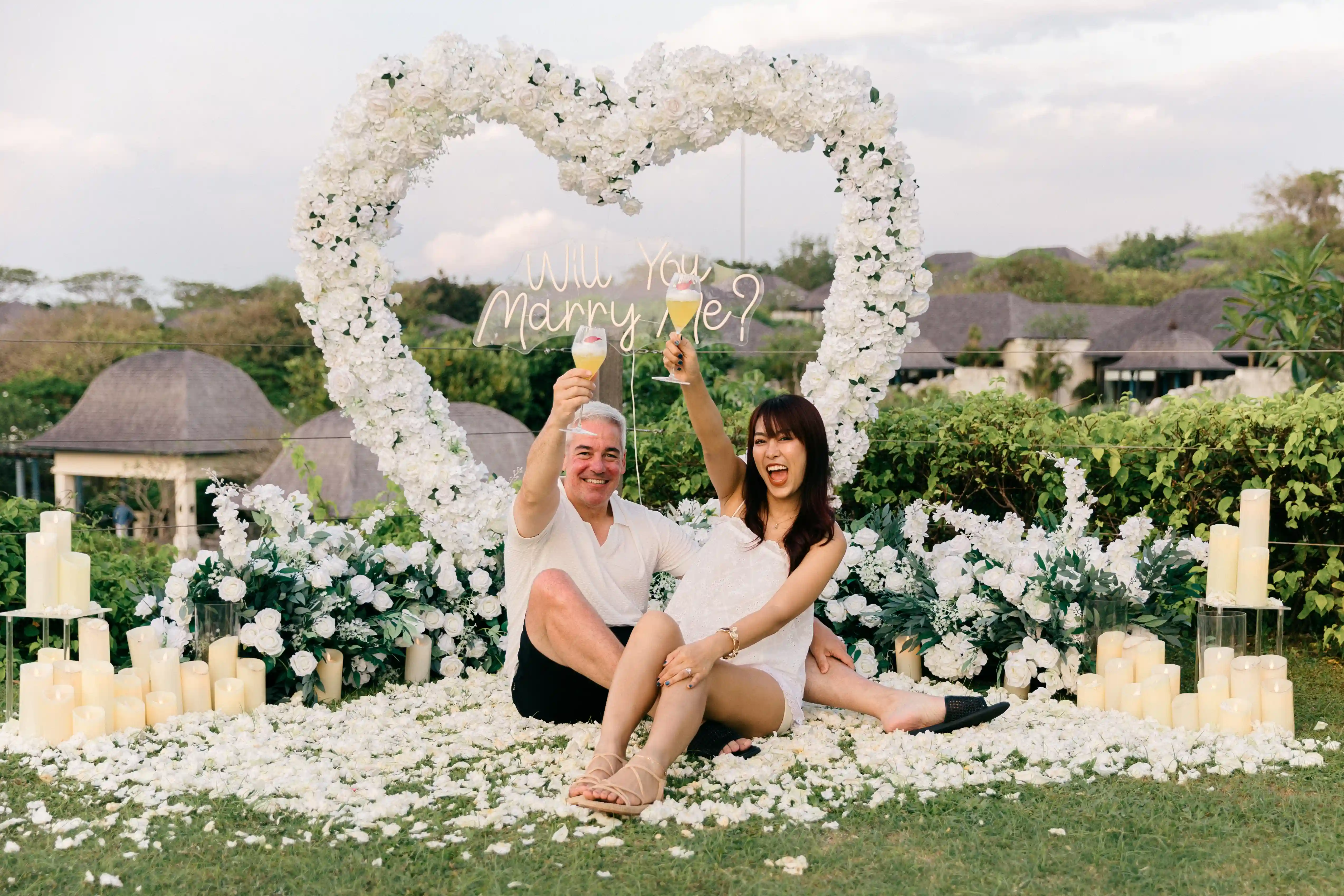Woman surprised during proposal setup with white flowers in Bali
