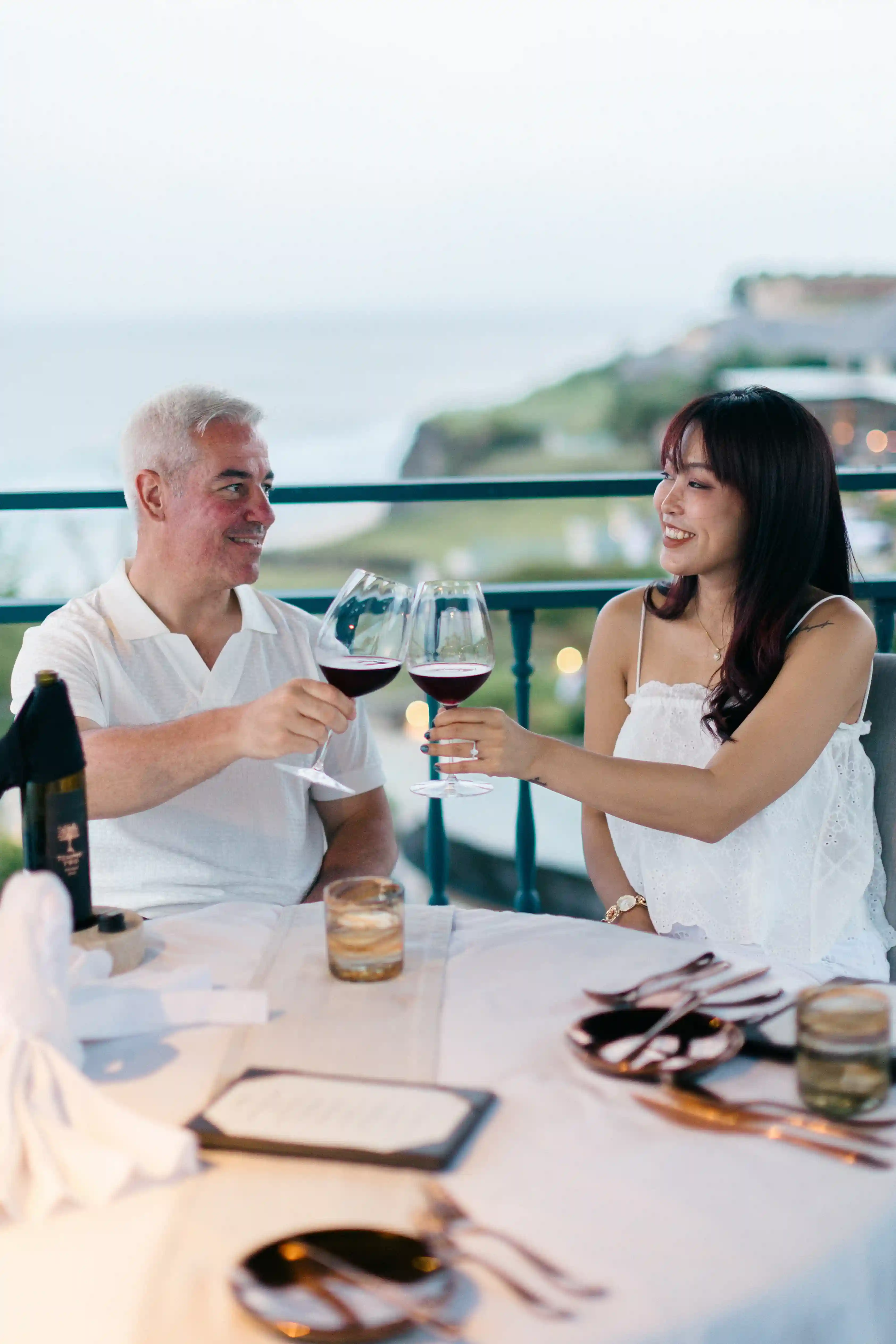 Couple toasting with wine during private dinner in Bali