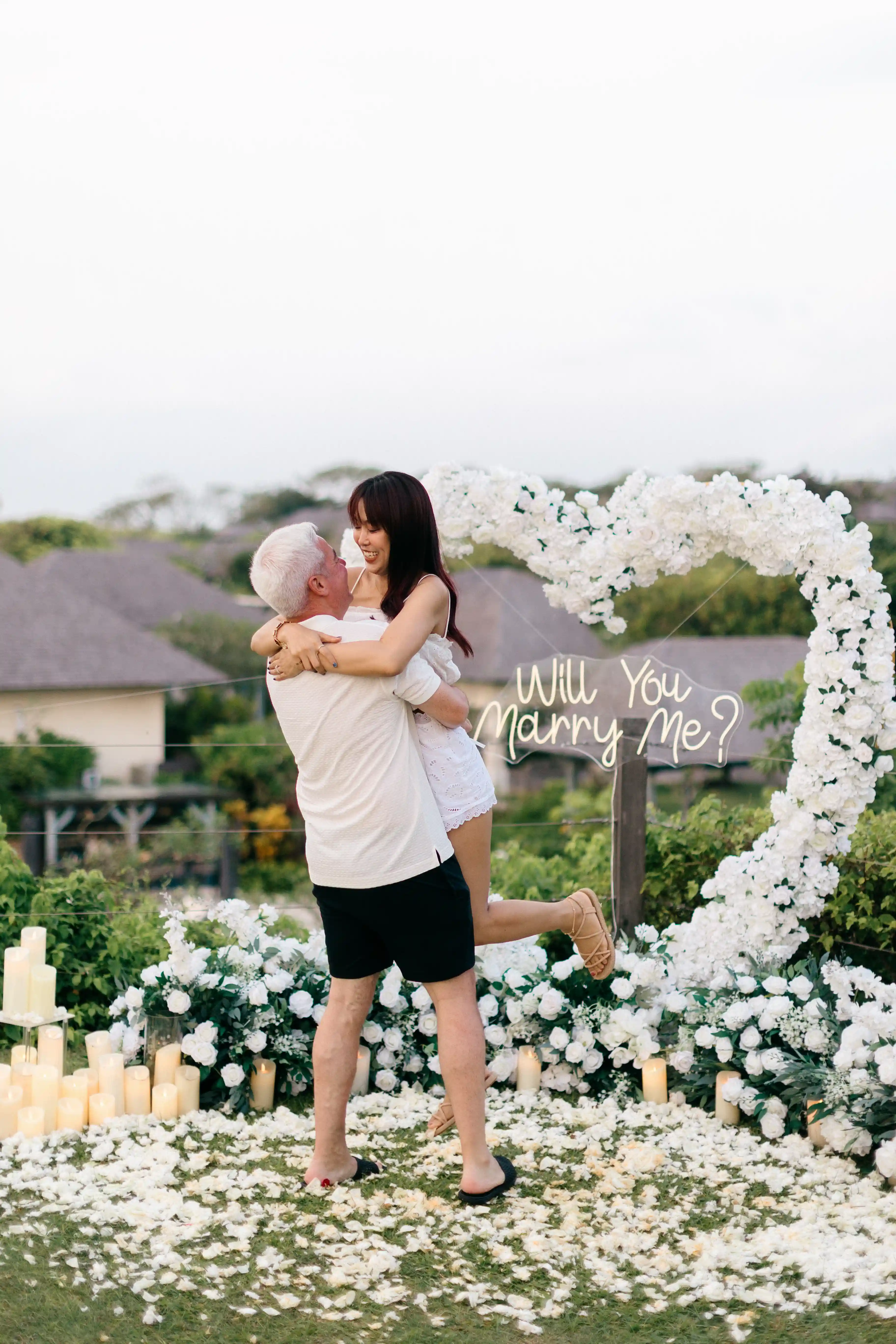Man hugging woman during proposal moment in Bali