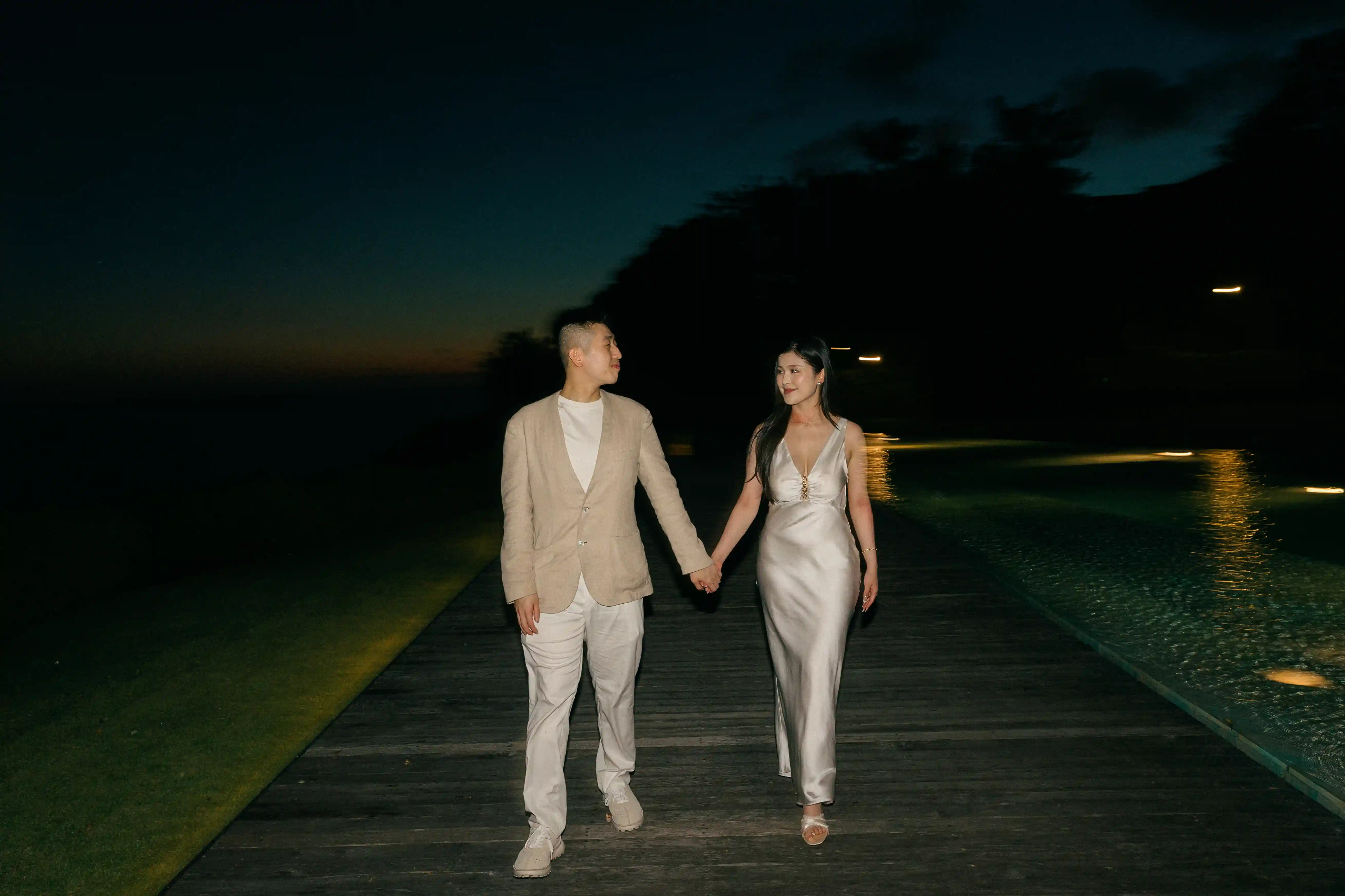 Couple walking together at night after their Bali engagement