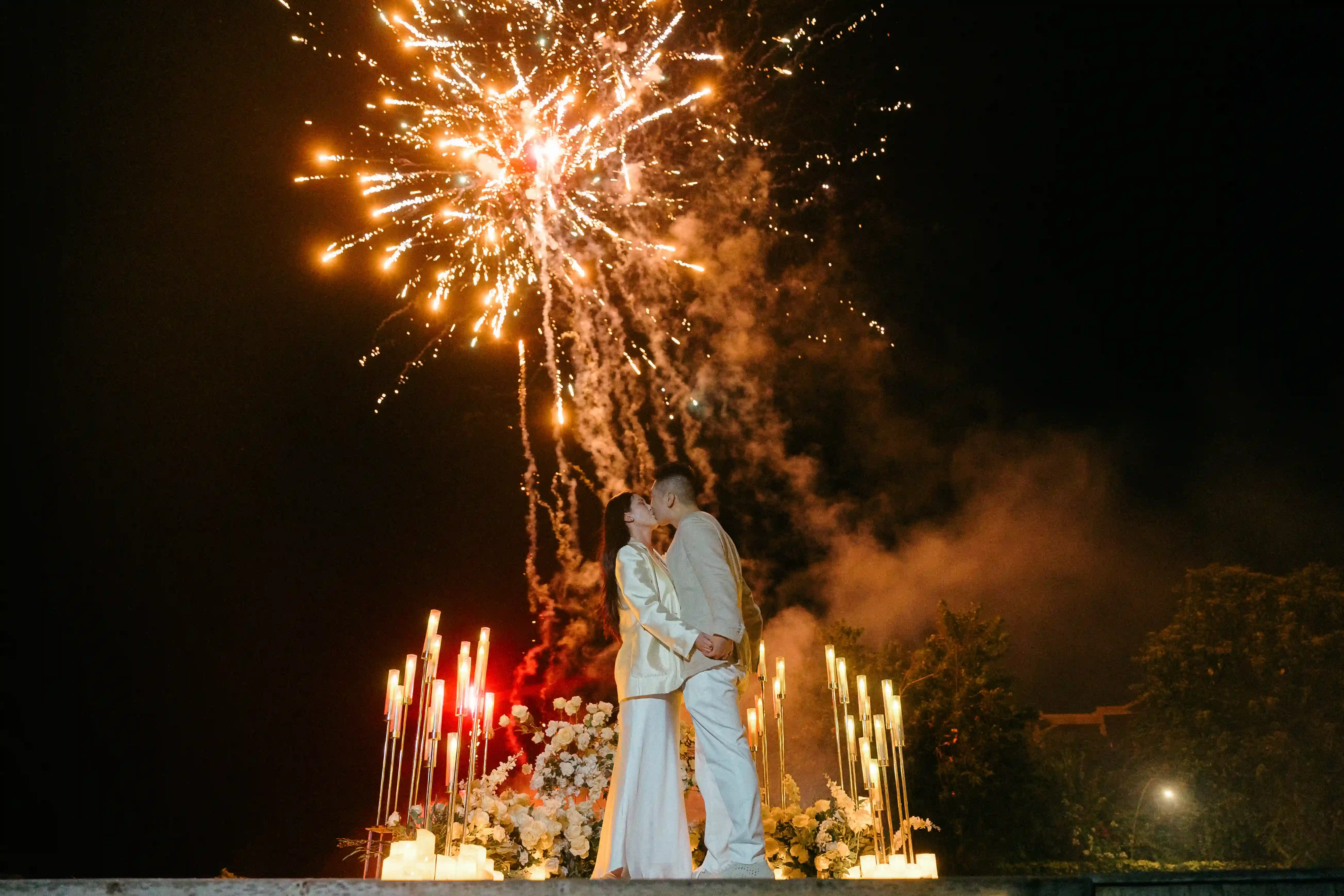 Romantic fireworks and candlelight during a Bali proposal celebration