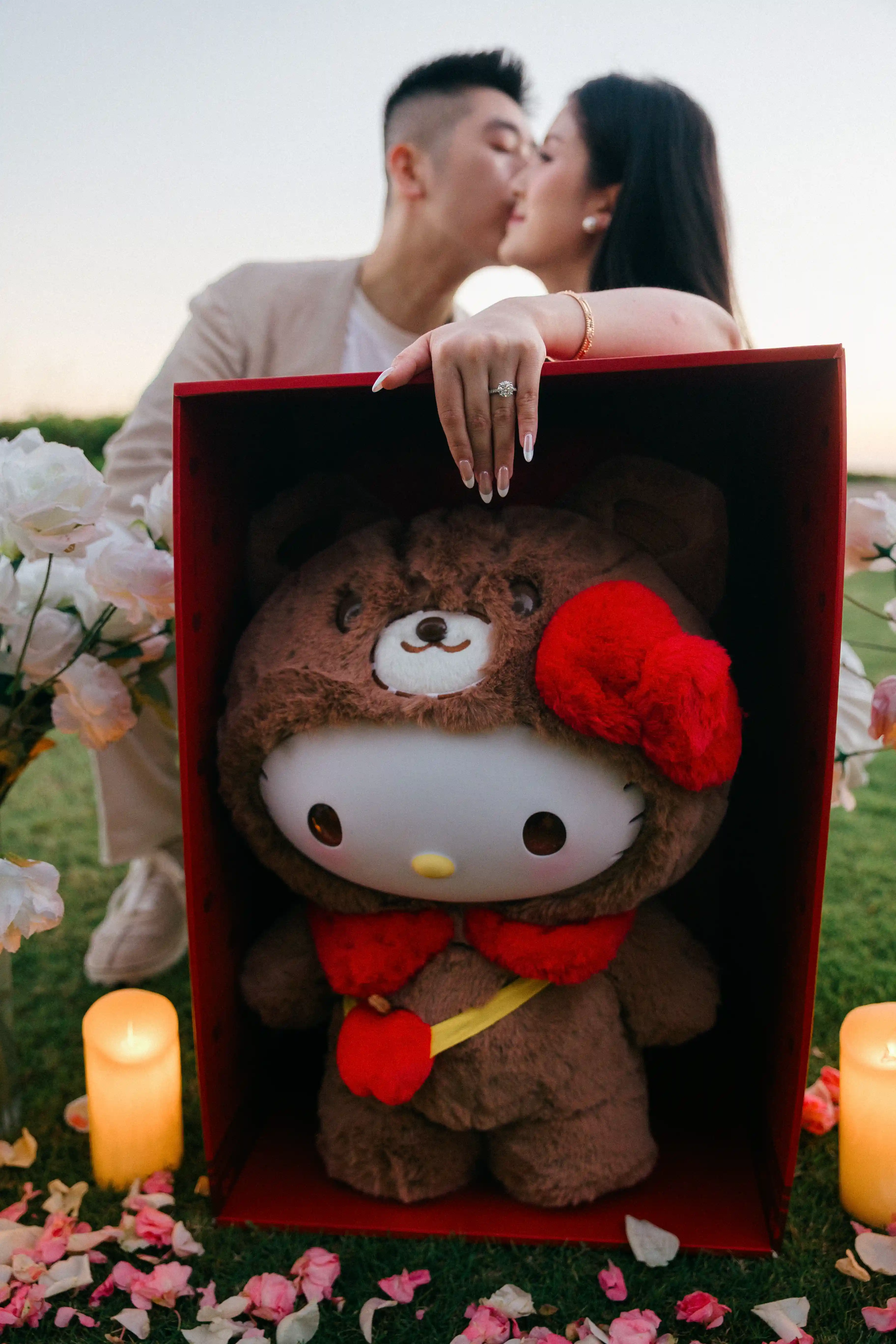 Couple celebrating engagement with a gift box after the proposal