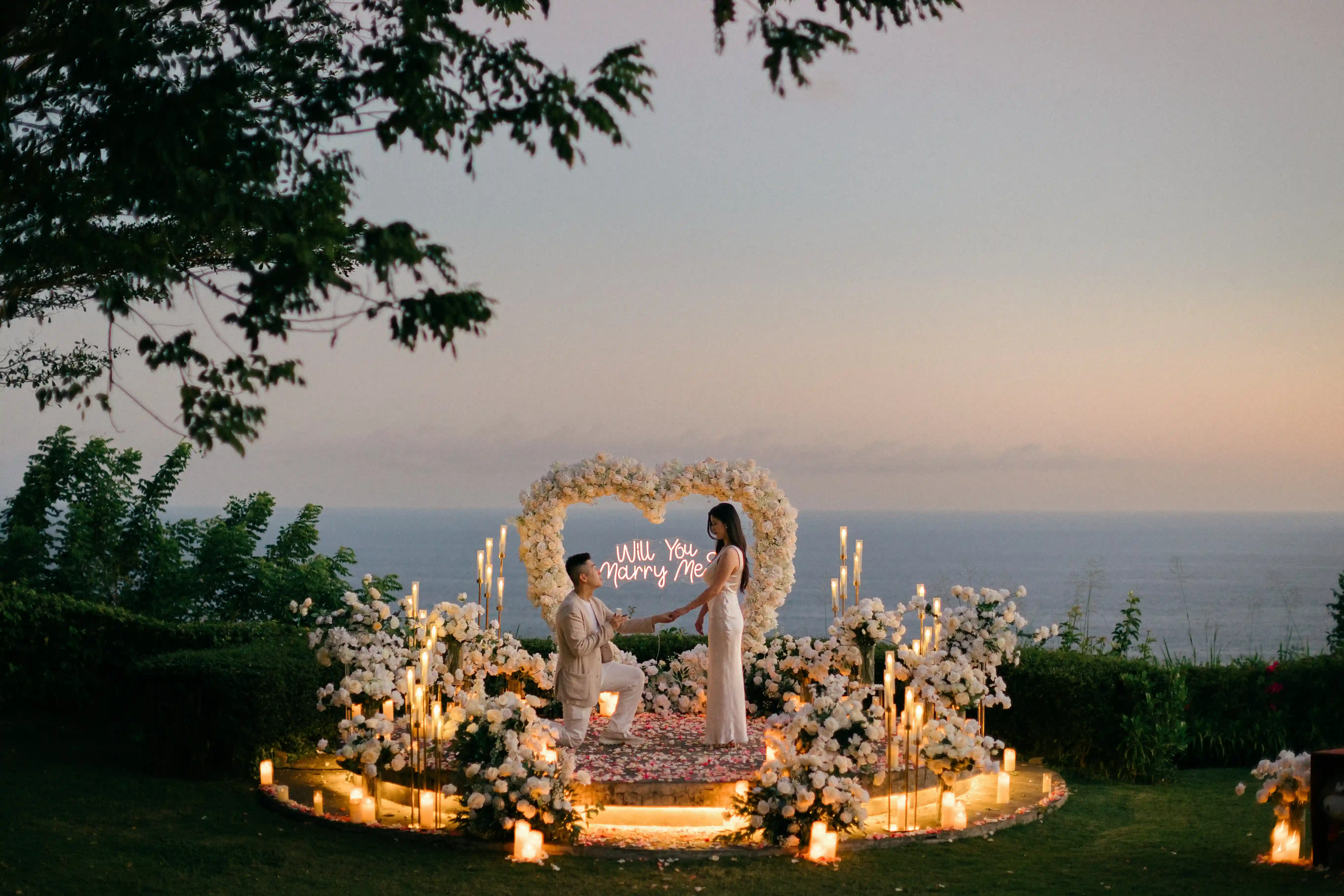 Private cliff proposal setup overlooking the ocean at sunset in Bali