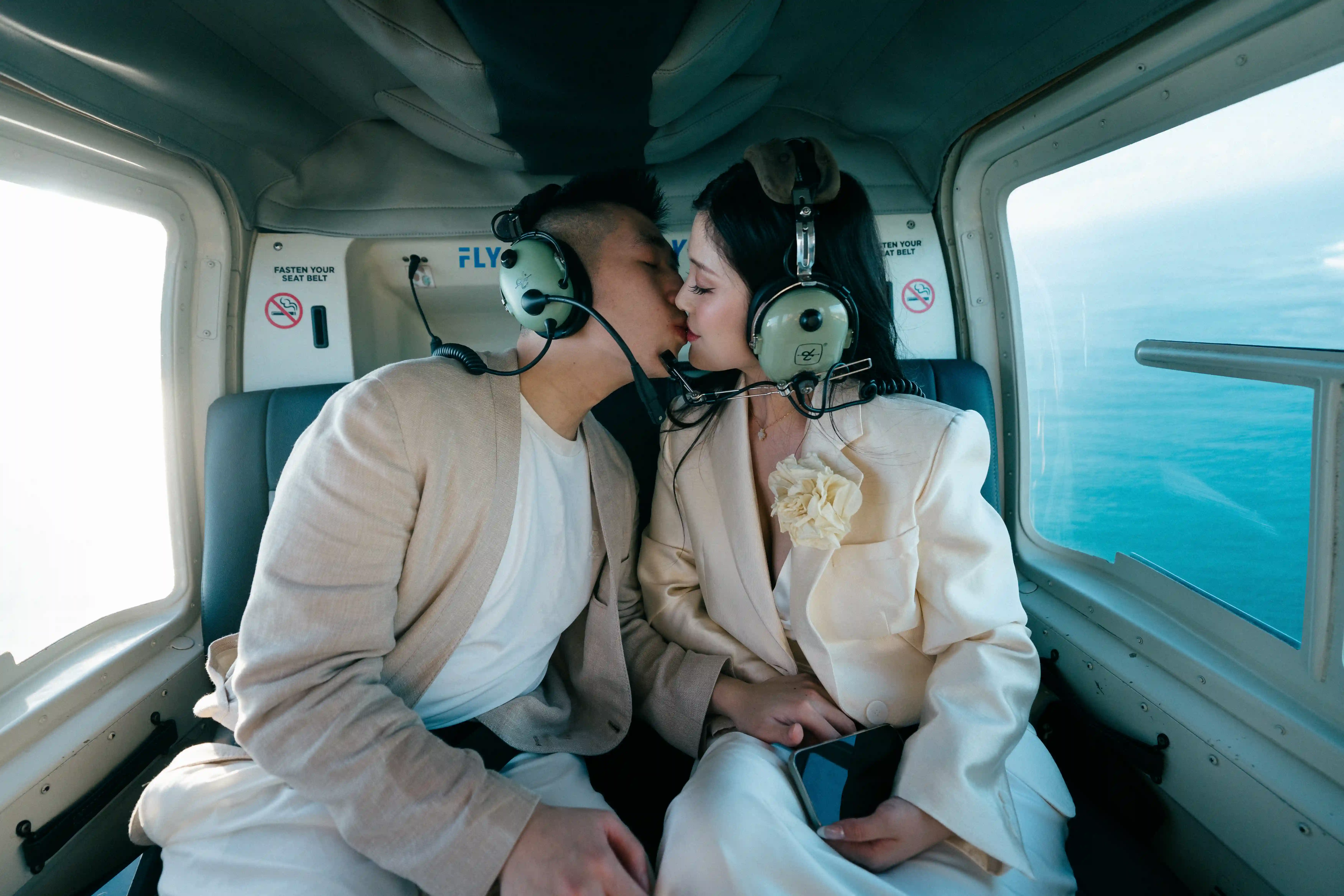 Couple kissing inside a helicopter during a private Bali helicopter tour