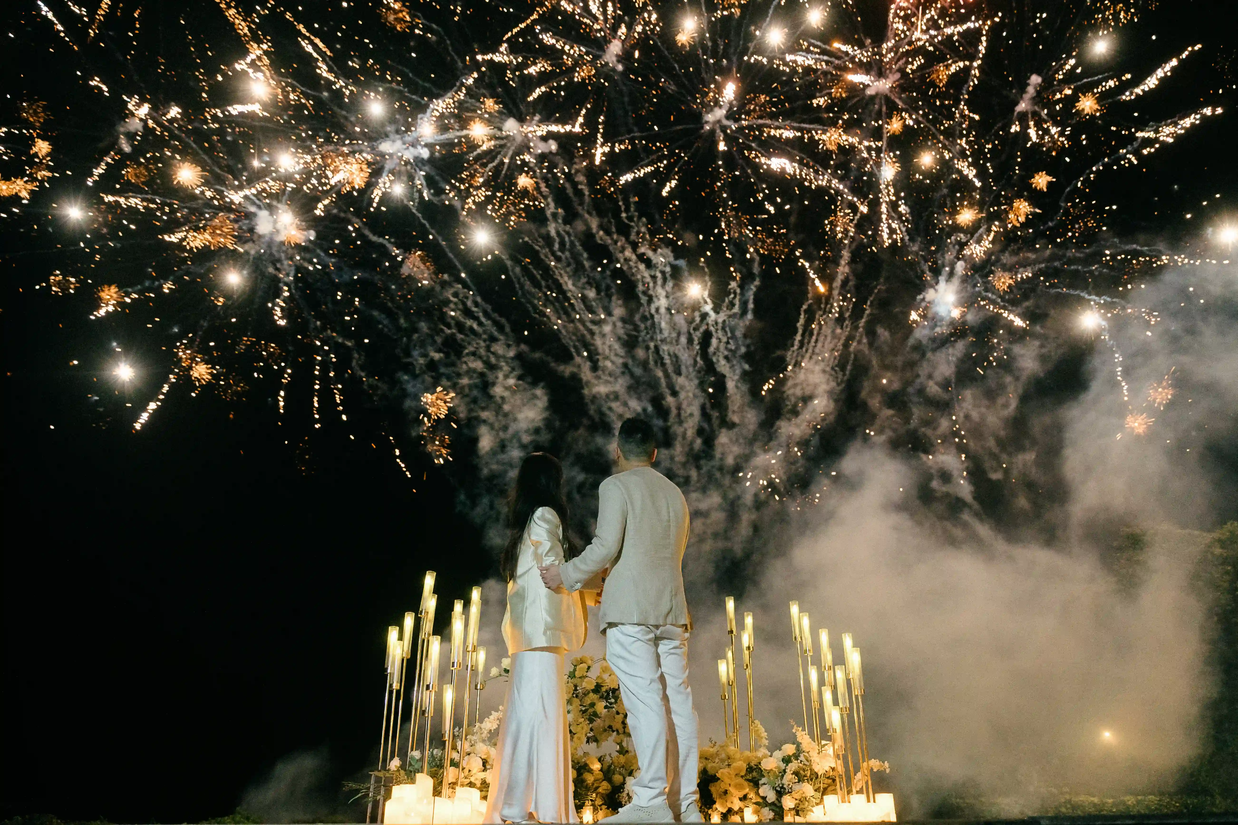 Fireworks exploding above a luxury Bali proposal celebration