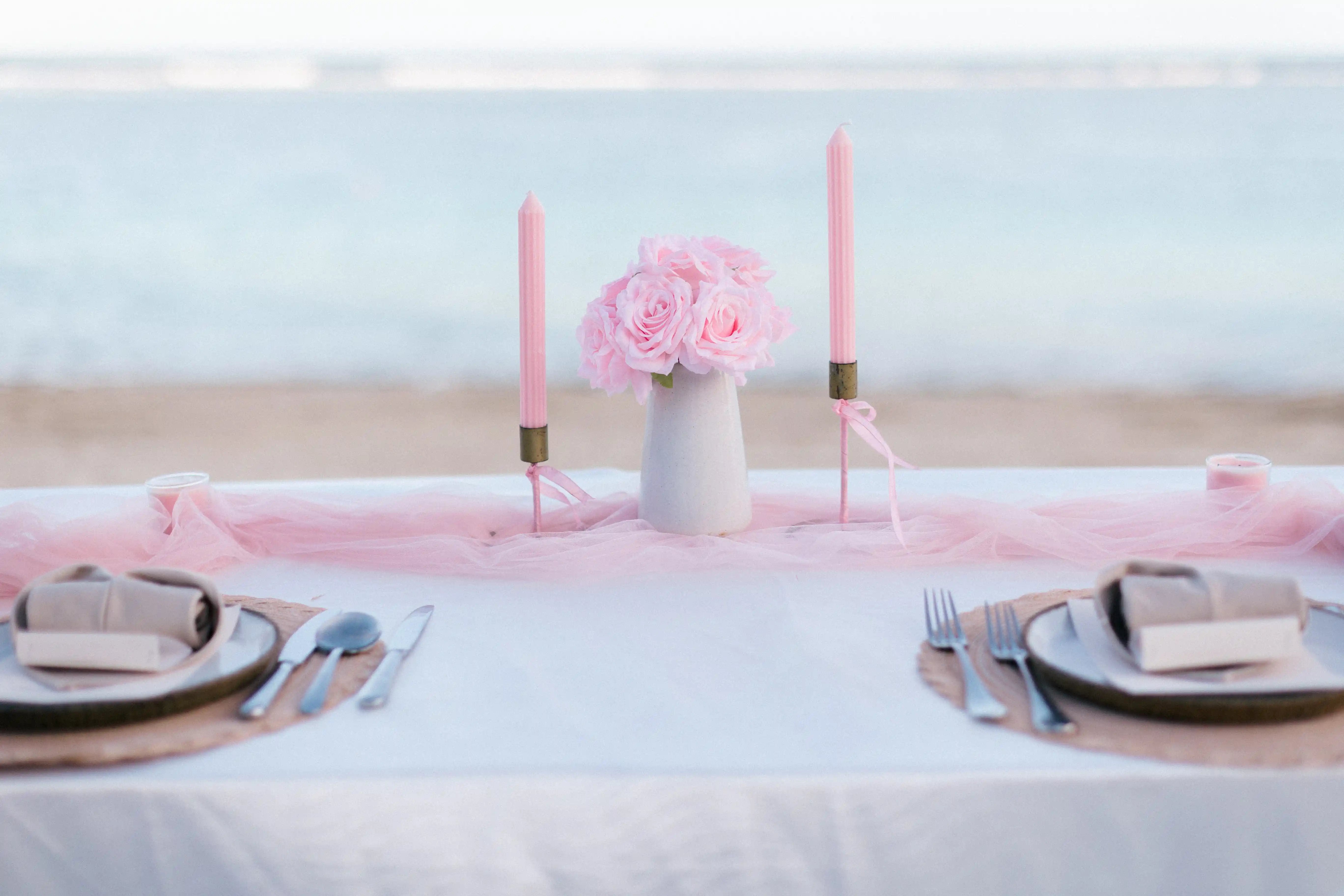 Elegant pink dinner table setup overlooking the ocean in Bali