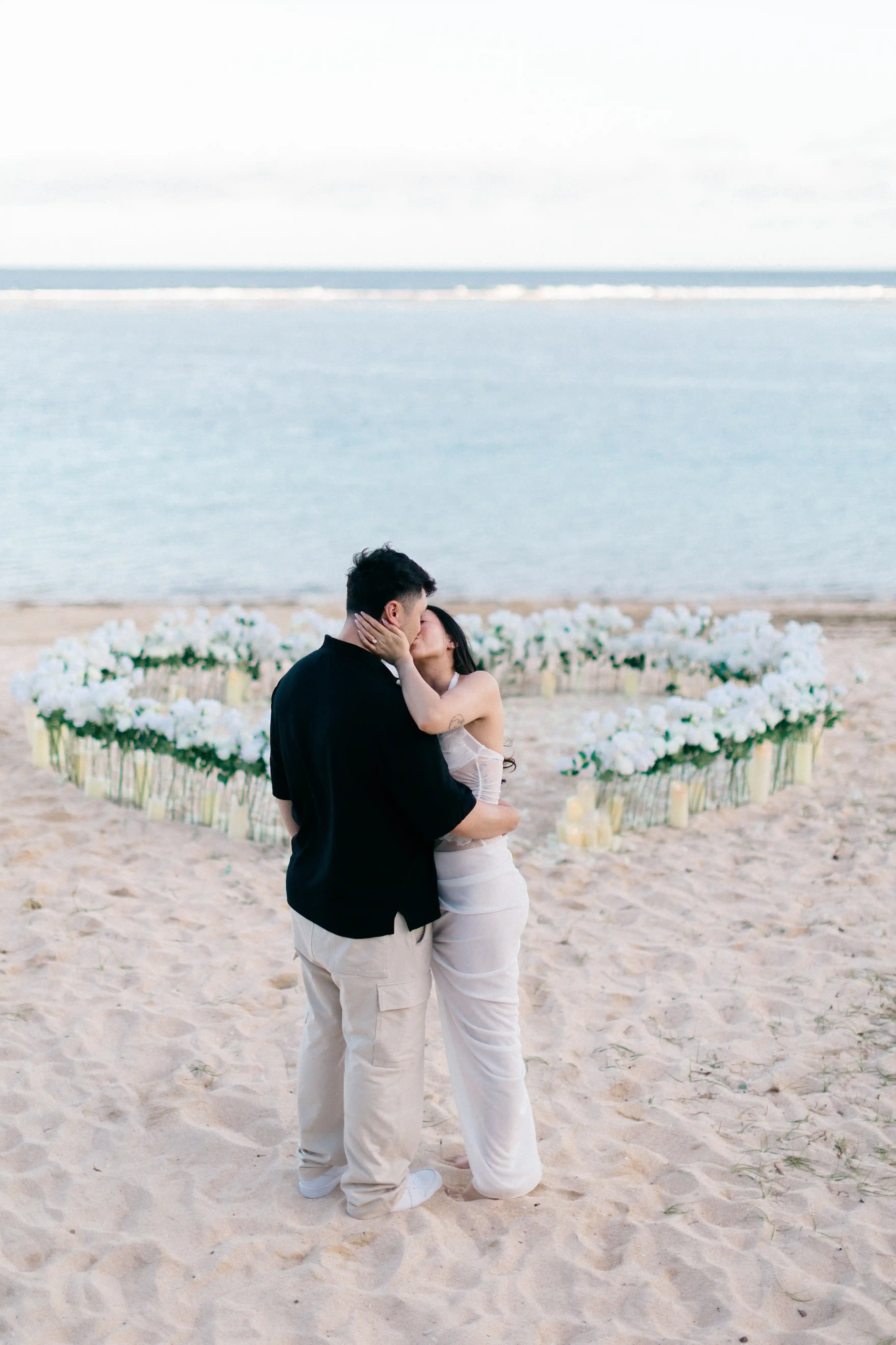 Romantic couple portrait by the ocean after Bali proposal