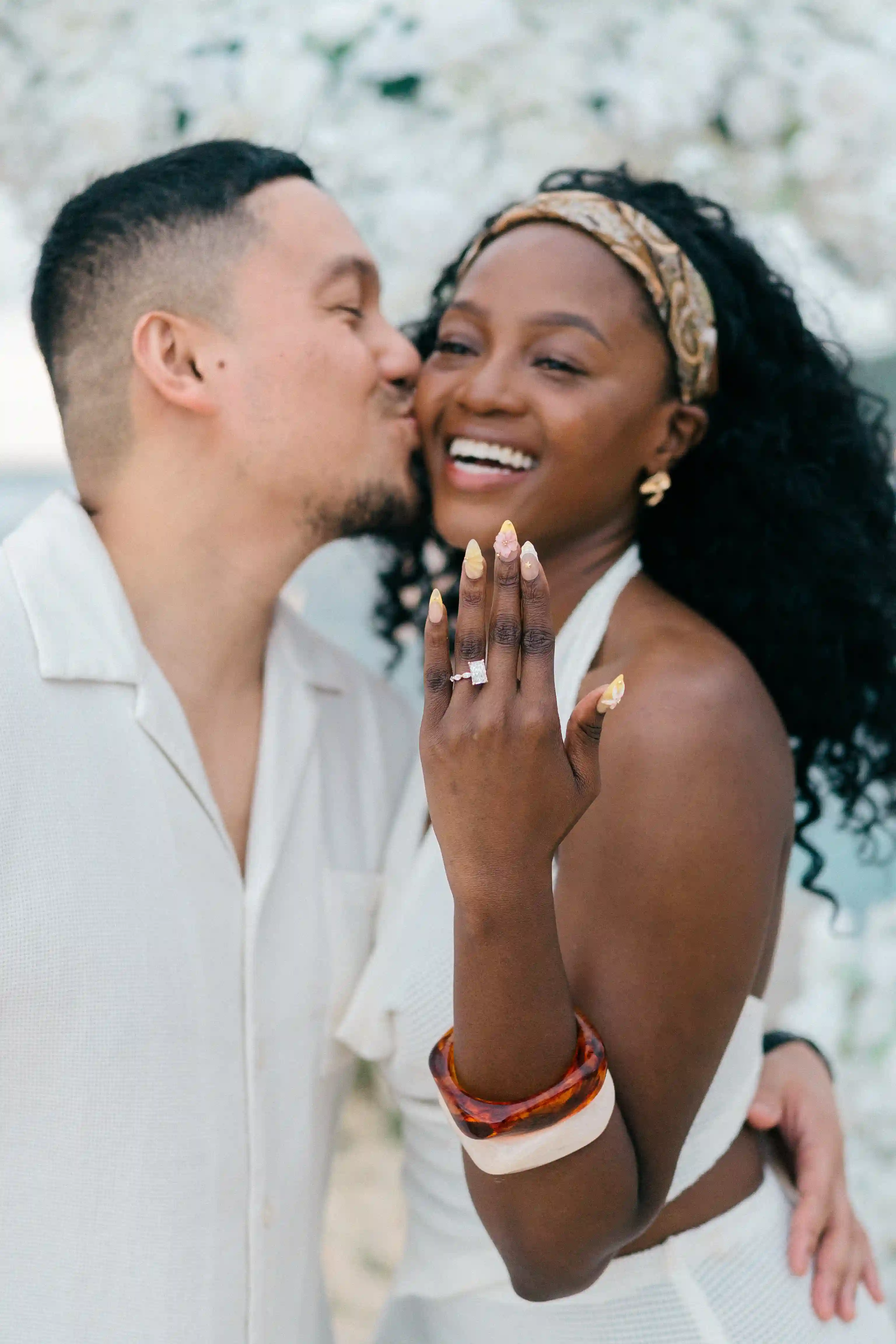 Newly engaged couple celebrating during beach cliff proposal in Bali