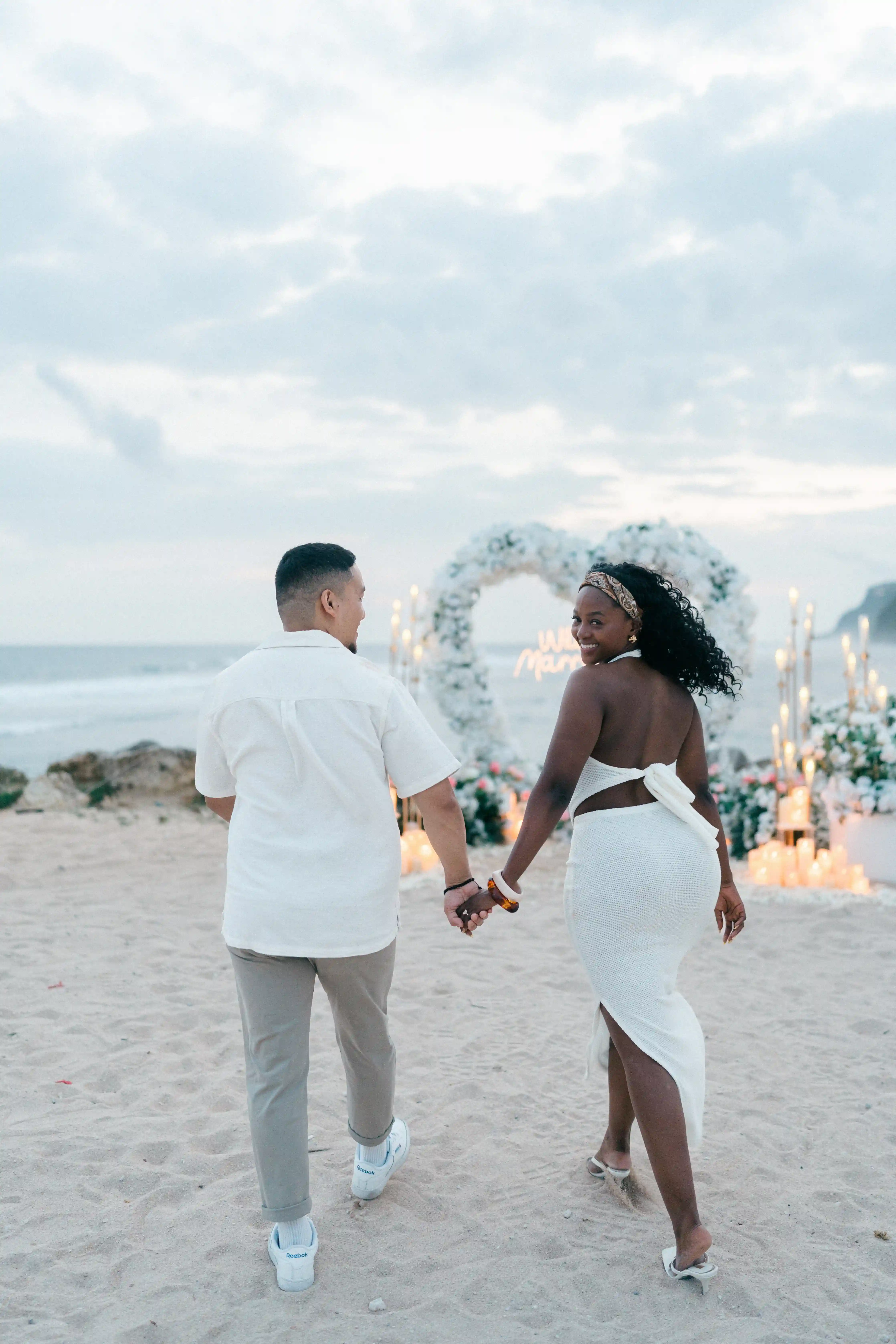 Couple walking hand in hand after sunset proposal in Bali