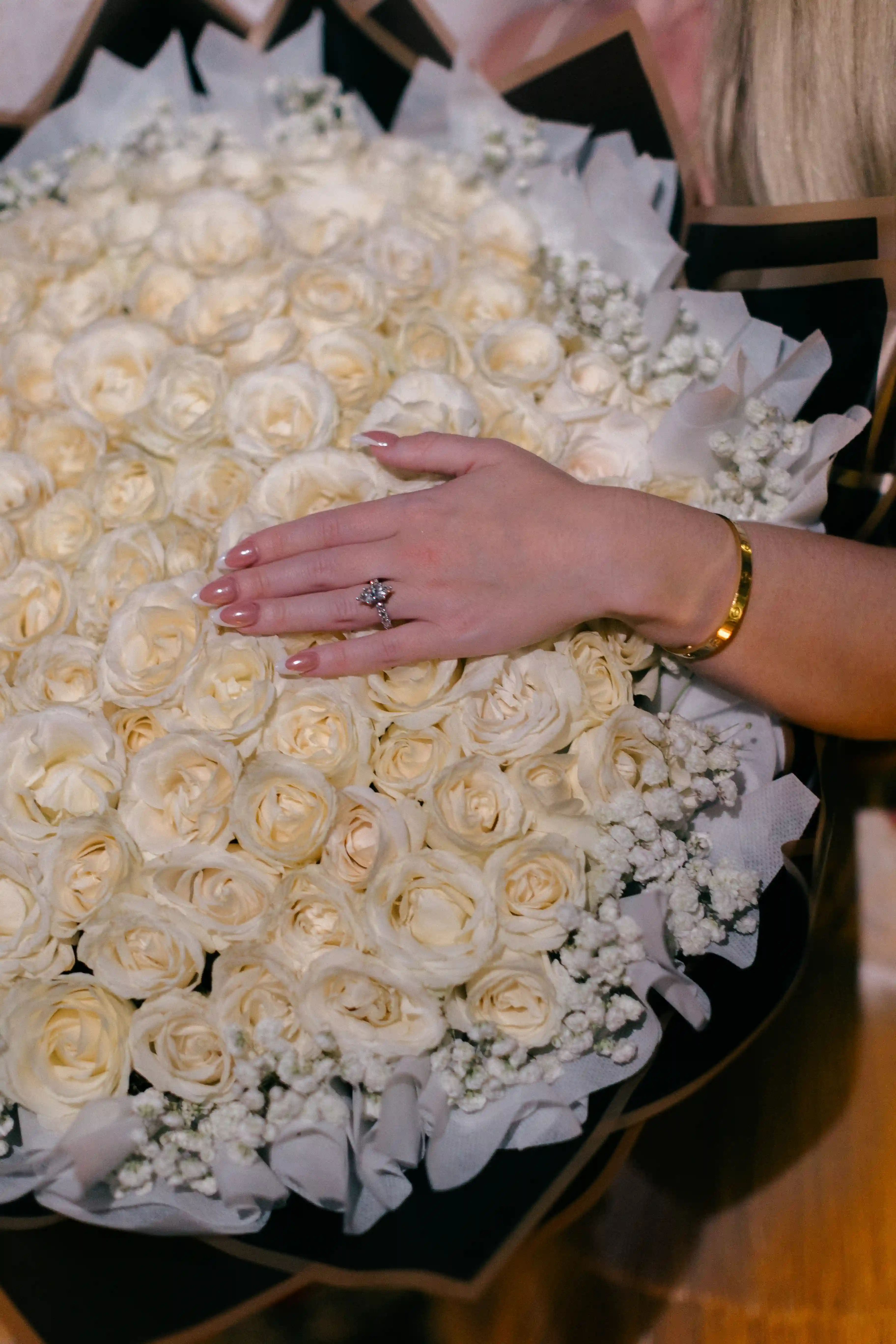 Close-up of white rose arrangement at luxury Bali proposal setup