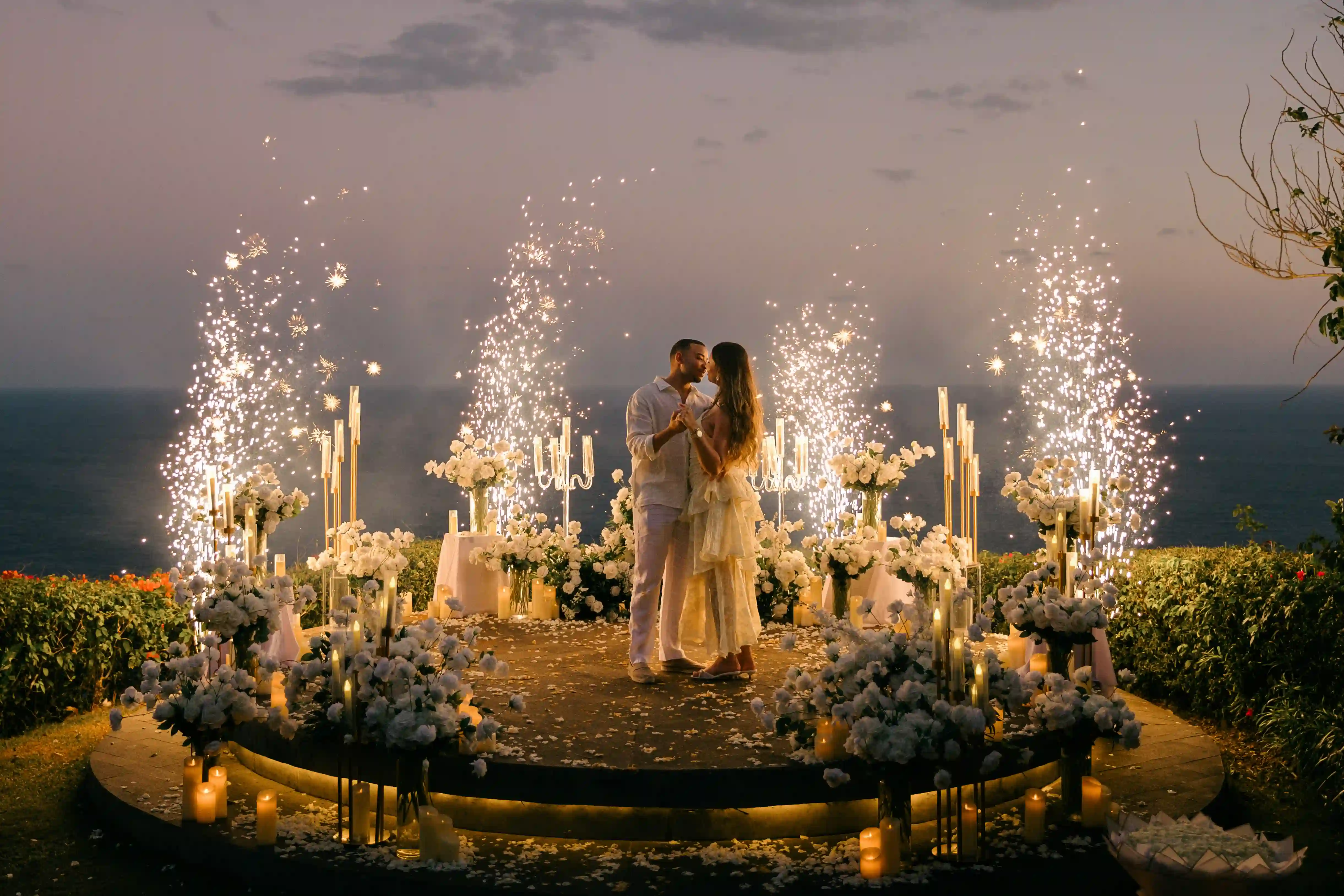 Sunset kiss with sparklers at a cliff proposal in Bali