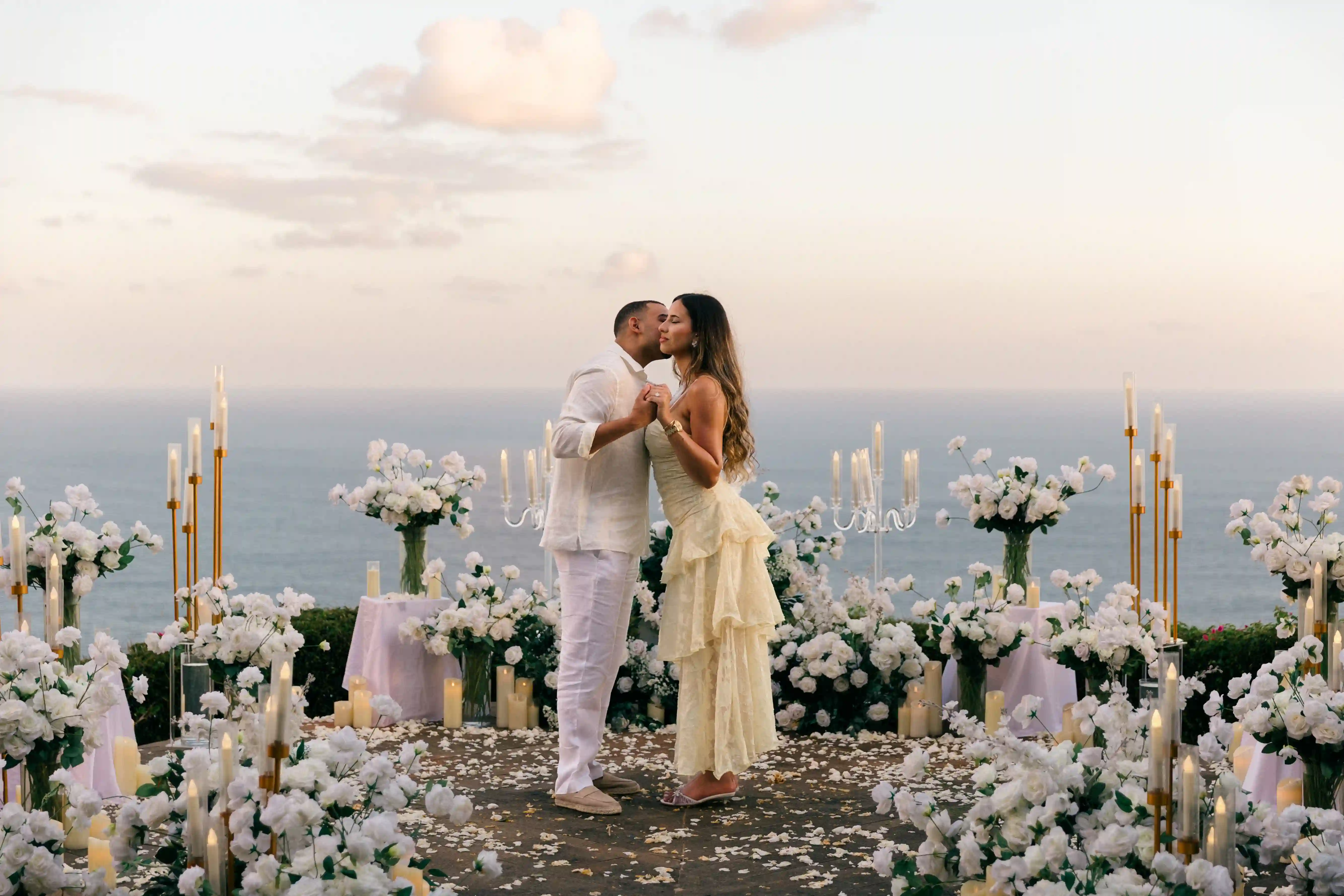 Couple kissing among sparklers at a clifftop proposal in Bali