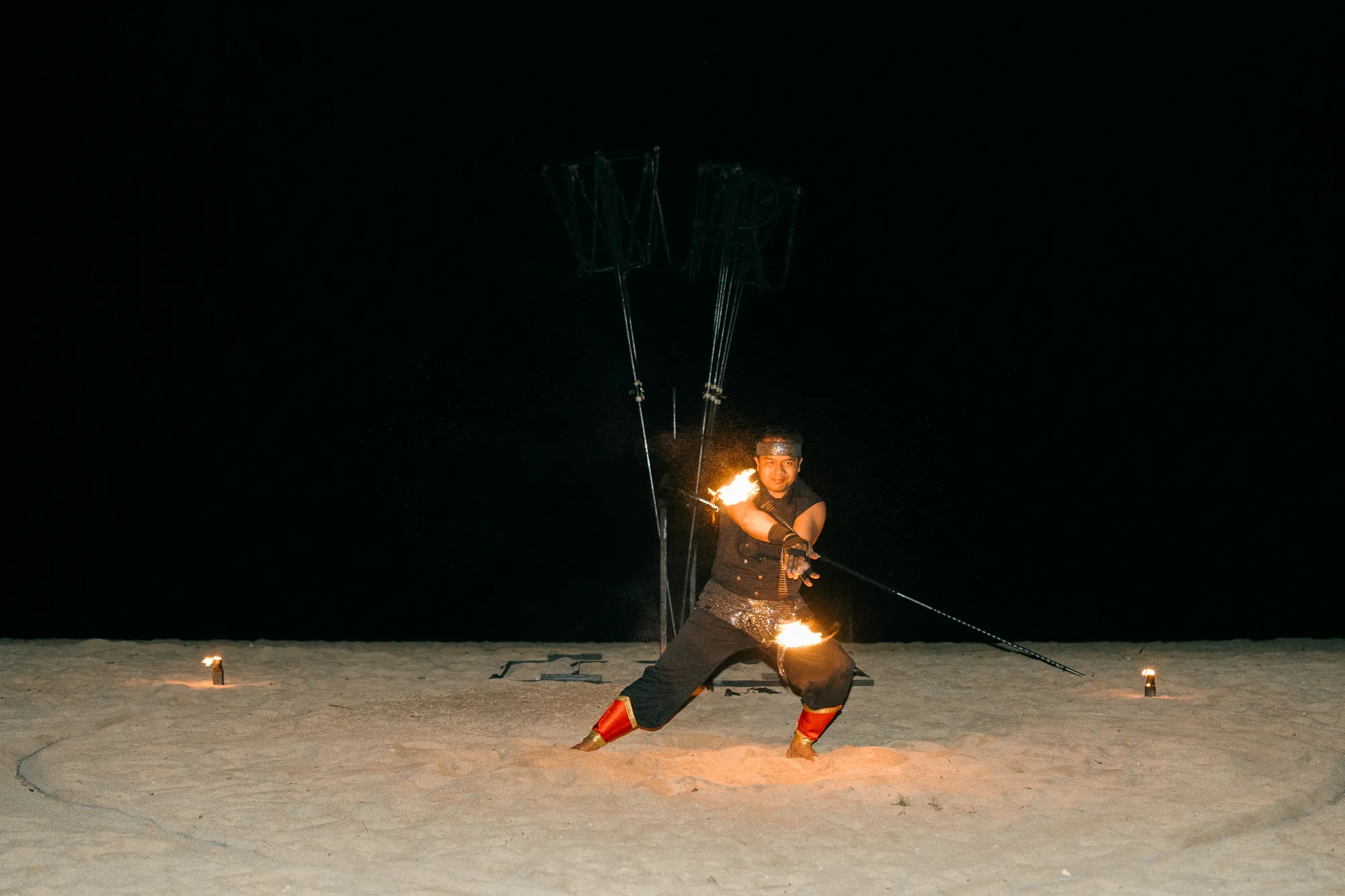 Fire performer spinning sparklers on the beach at a Bali proposal