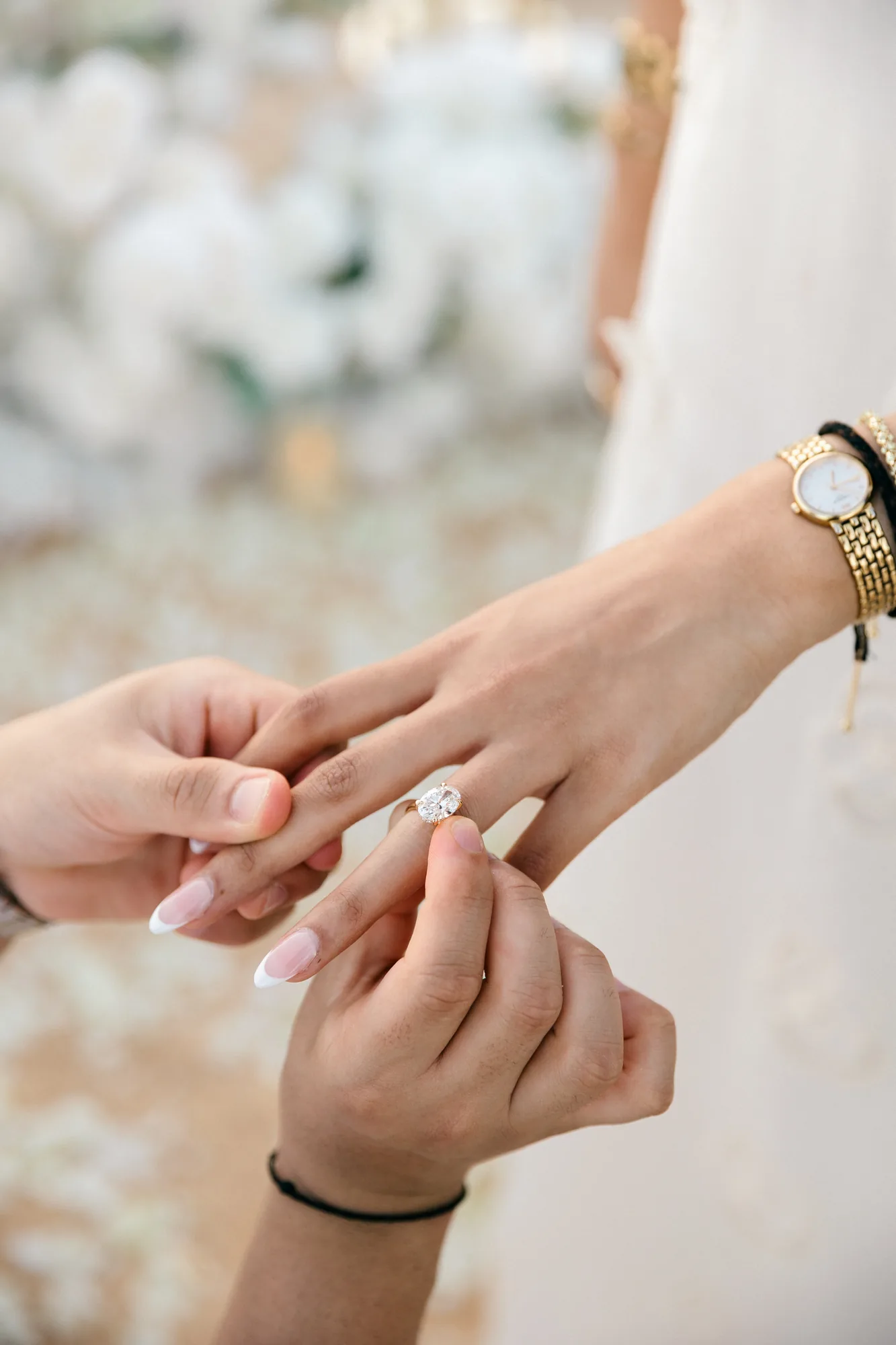 Close-up of an engagement ring being placed on the finger at a Bali proposal