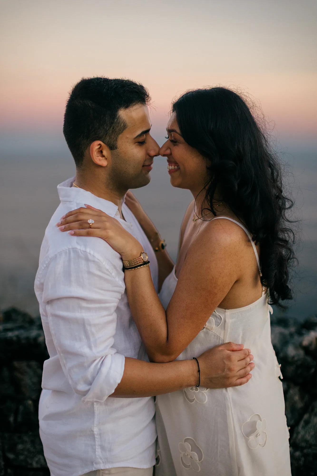 Close-up couple portrait forehead to forehead at sunset during a Bali proposal