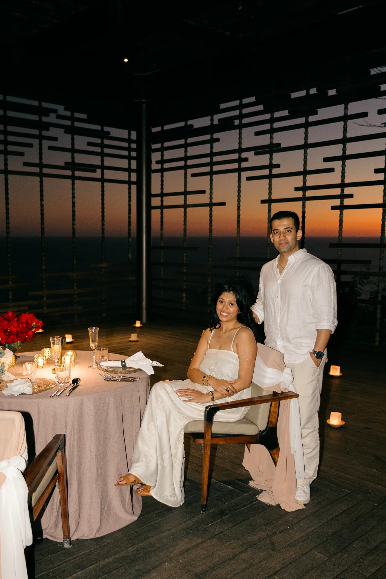 Couple at an intimate candlelit dinner in a cliffside pavilion during their Bali proposal