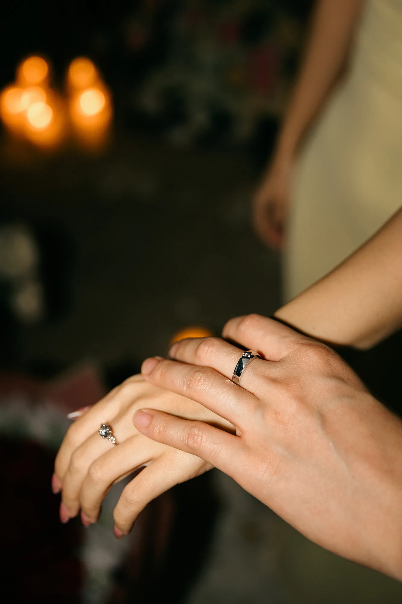 Close-up of the engagement ring on her hand by candlelight at a Bali proposal