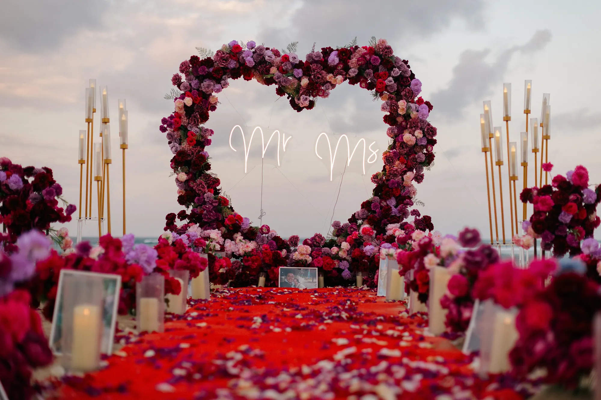Red rose heart arch with a Mr and Mrs sign at a Bali beach proposal
