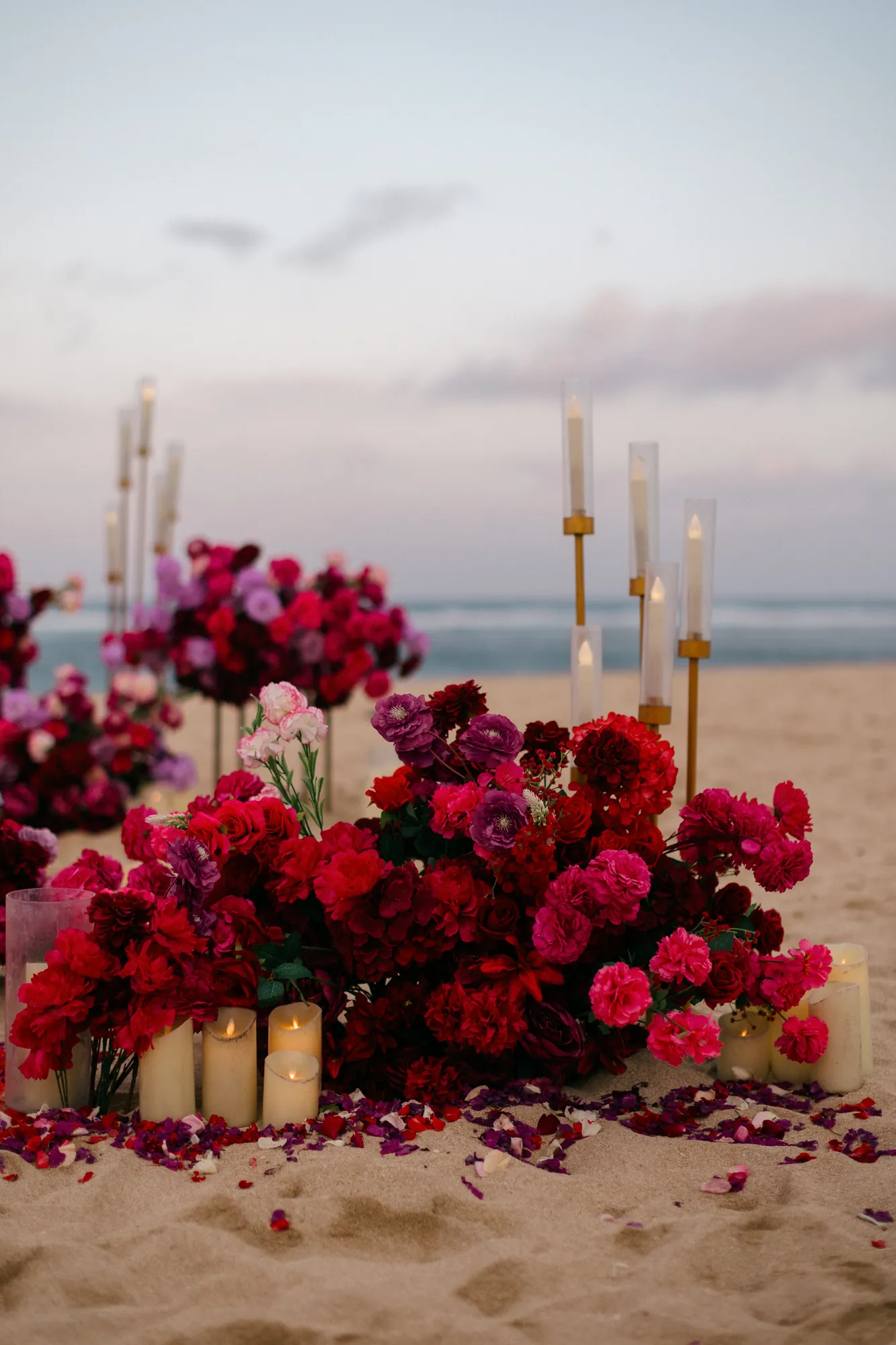 Red and pink rose floral setup on a Bali beach at a firework proposal