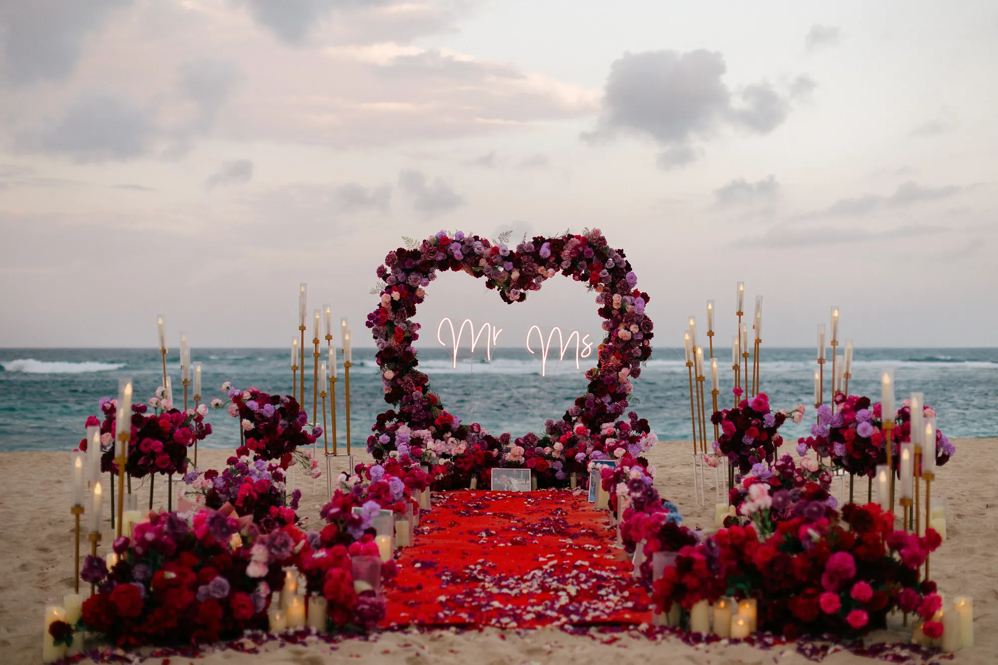 Red rose heart arch overlooking the ocean at a Bali beach proposal