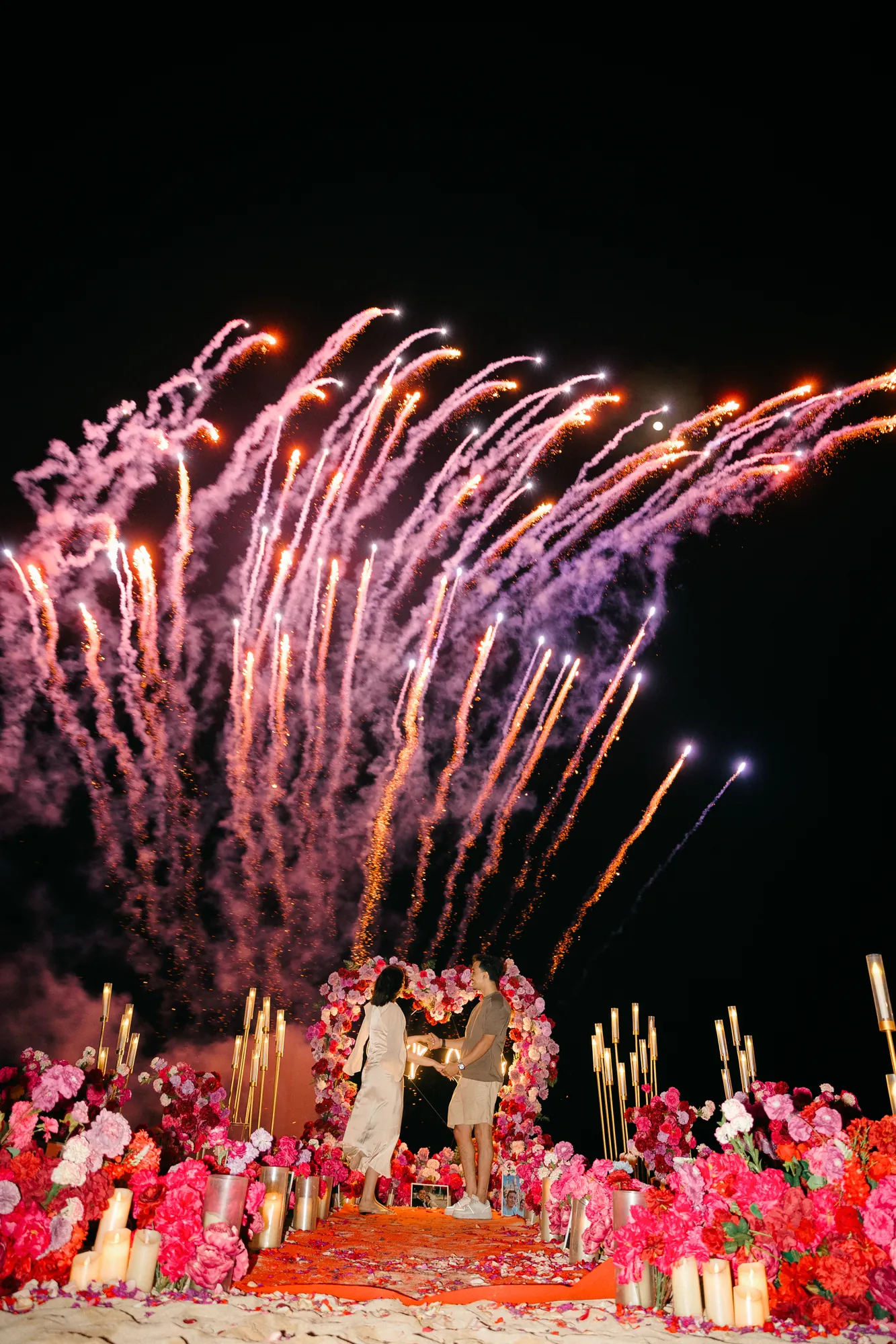 Fireworks over a beach proposal setup in Bali at night