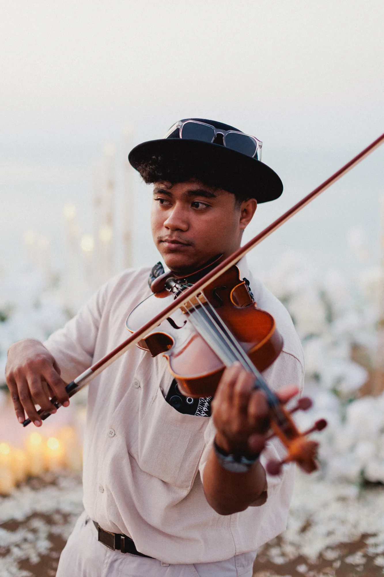 Portrait of a violinist at a Bali cliff proposal