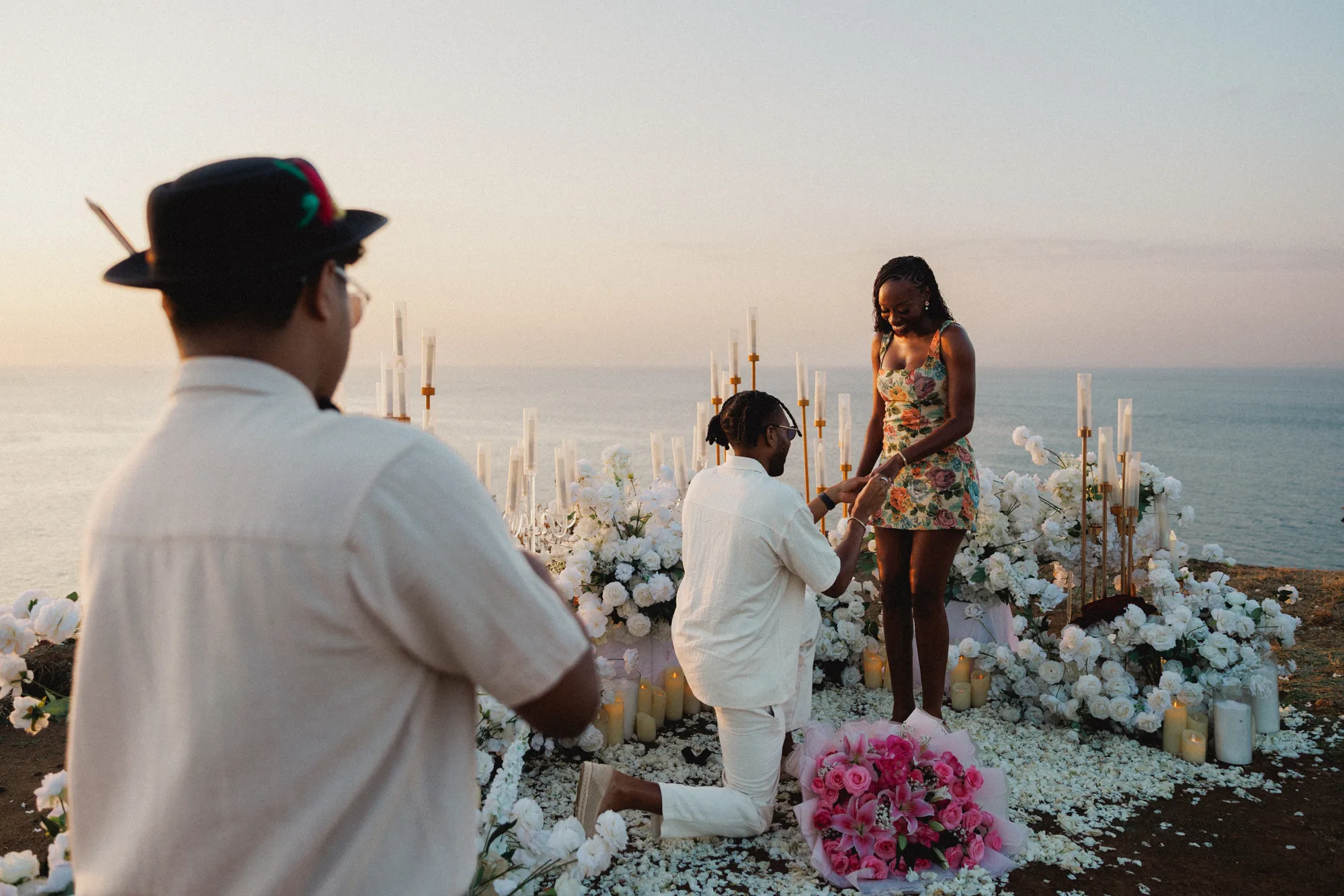 Man kneeling to propose at a Balangan clifftop proposal in Bali