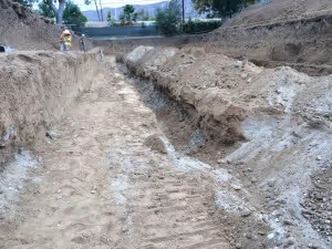 Fault trench with geologists examining trench walls [Sean Lin]