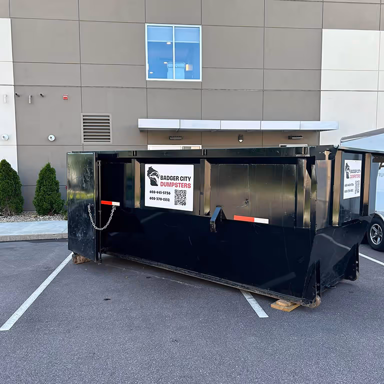 A dumpster being utilized during a hotel renovation