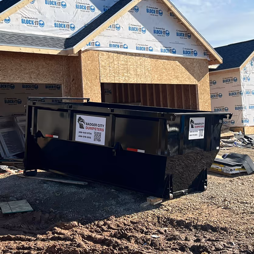 A dumpster at a residential construction site