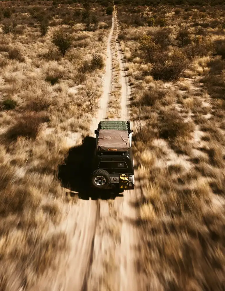 A car on the road in the middle of the Kalahari desert