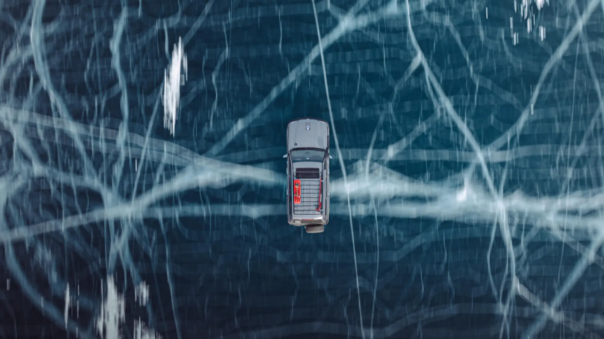 A car through remote desert landscapes during a Nomadic Road expedition