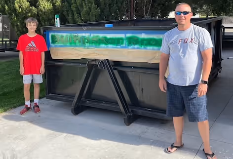 Me and my son painting our logo on our first dumpster
