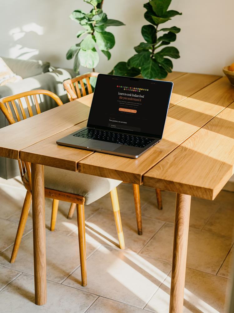 HowToMasala landing page on MacBook Pro desktop with plant