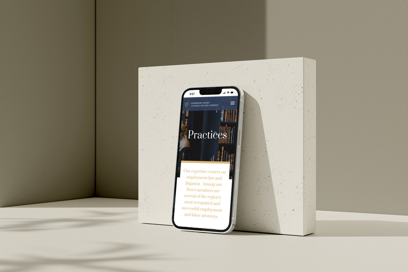 Smartphone displaying a legal practice webpage with text about employment law and litigation, leaning against a textured beige block.