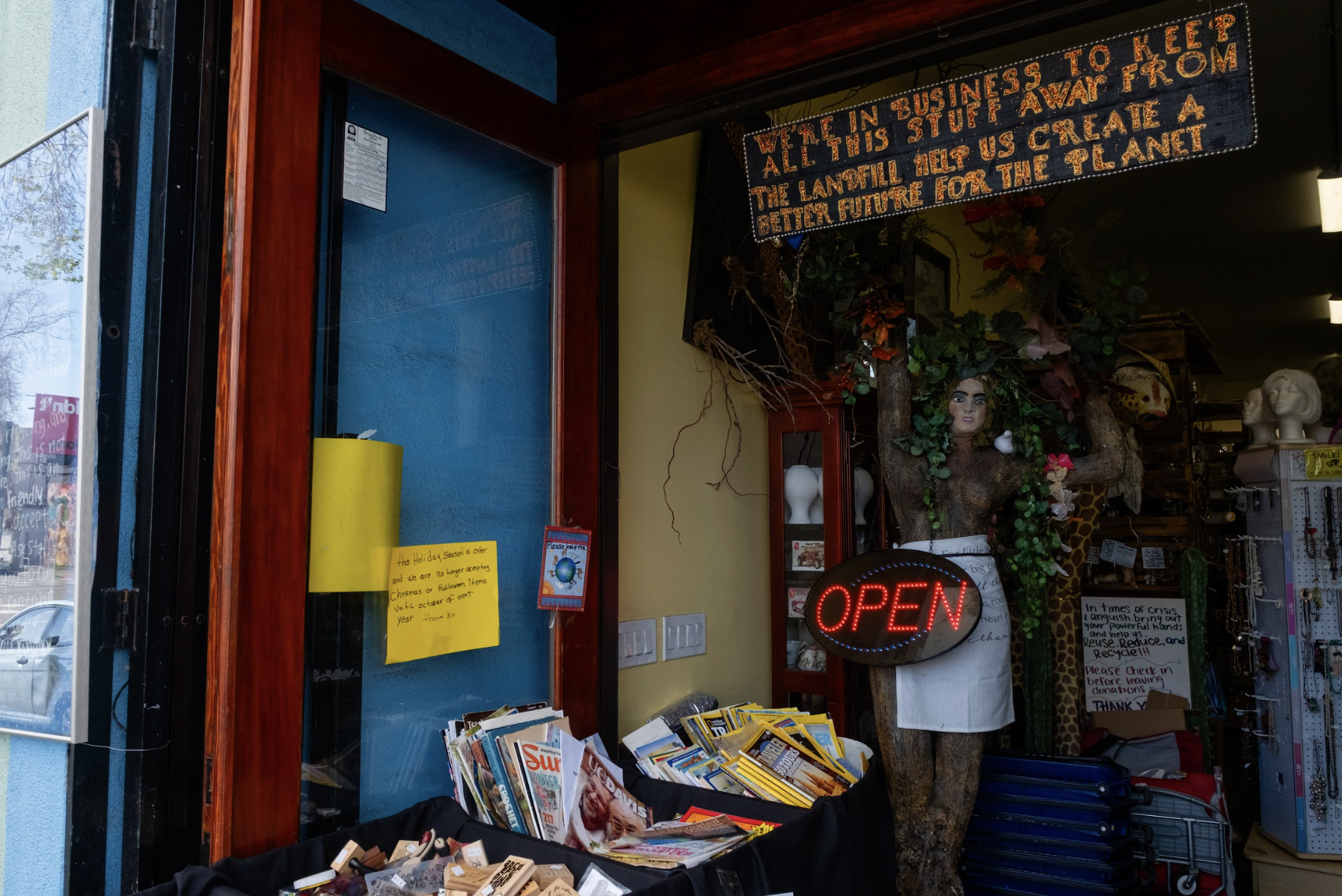 Image of open sign and front door area of the thrift store